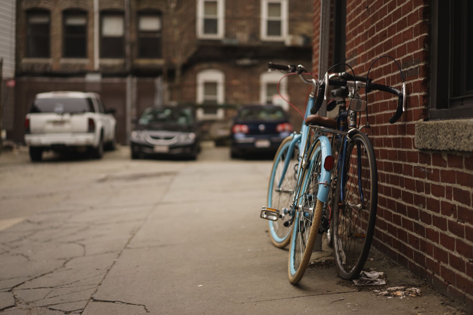 Sony a7 + Sony Sonnar T* FE 55mm F1.8 ZA sample photo. Alley, bicycles, brick wall photography