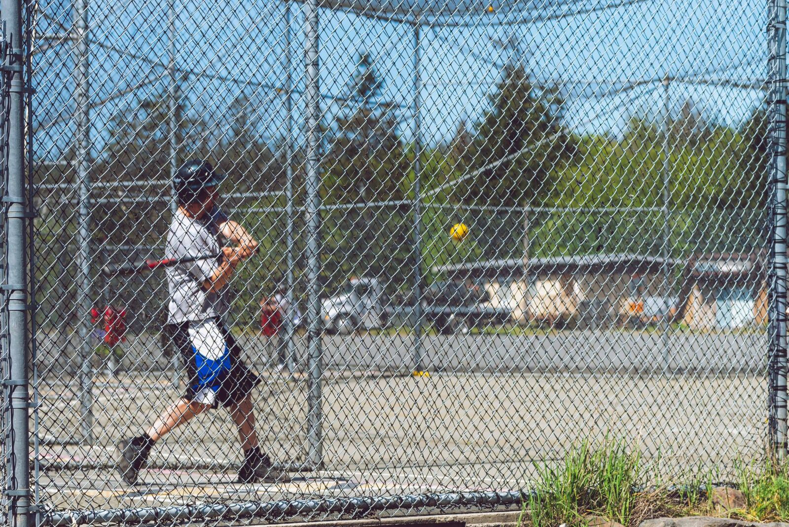 Nikon D750 sample photo. Batting cages, softball, baseball photography