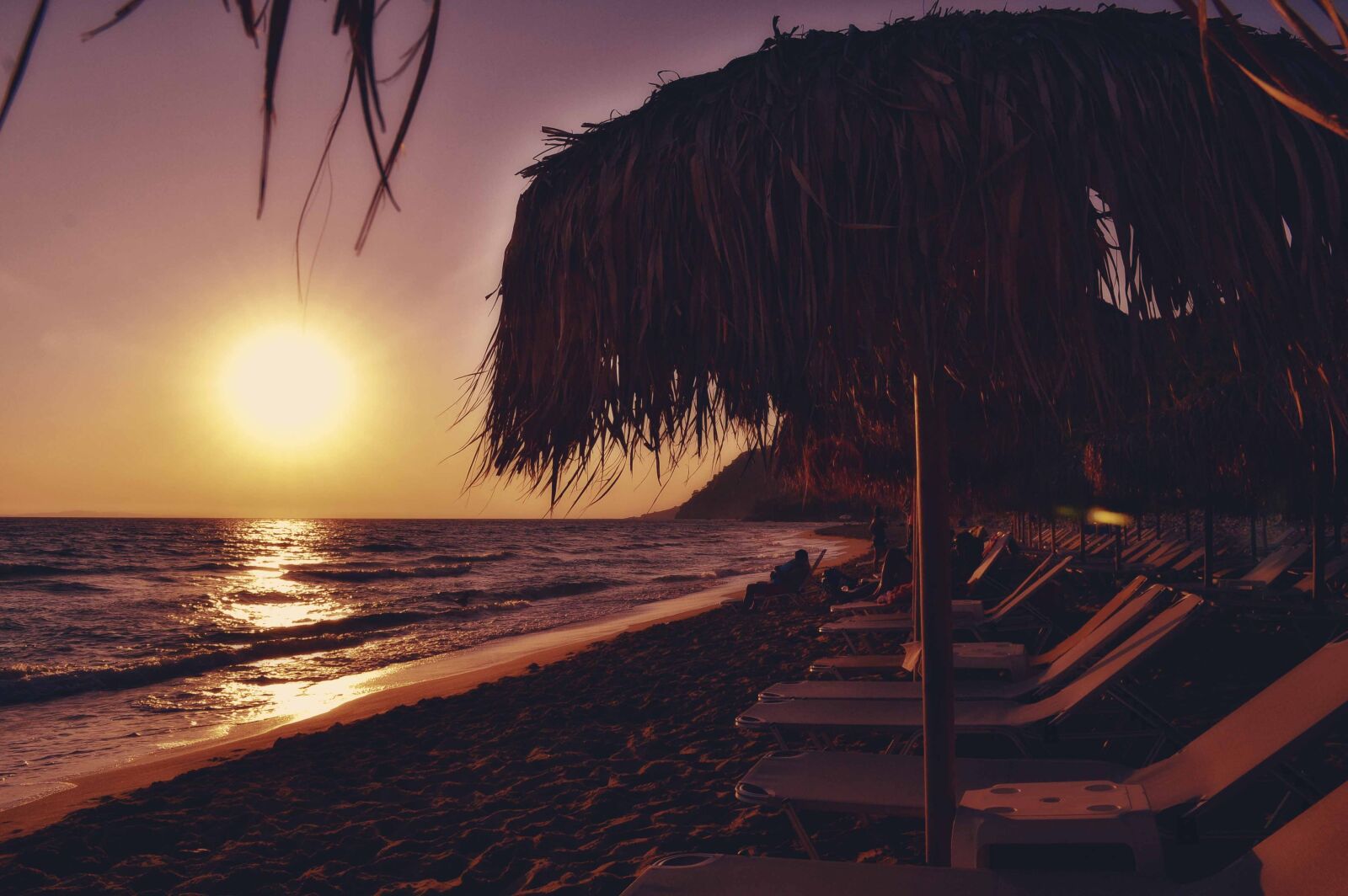 Nikon D3100 sample photo. Sunset beach seascape, sunbeds photography