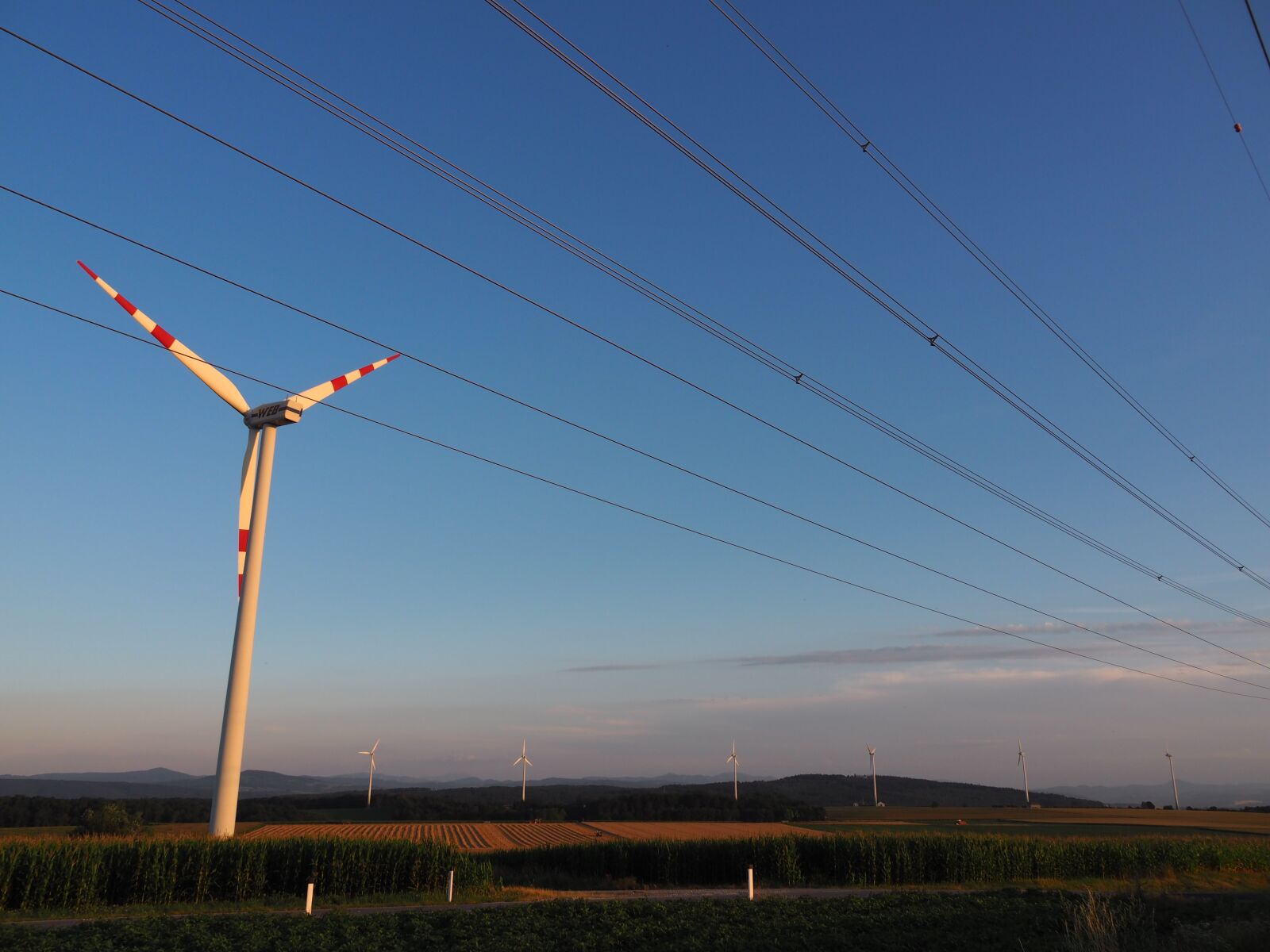 Olympus PEN E-PL7 sample photo. Pinwheel, alternative energy, wind photography
