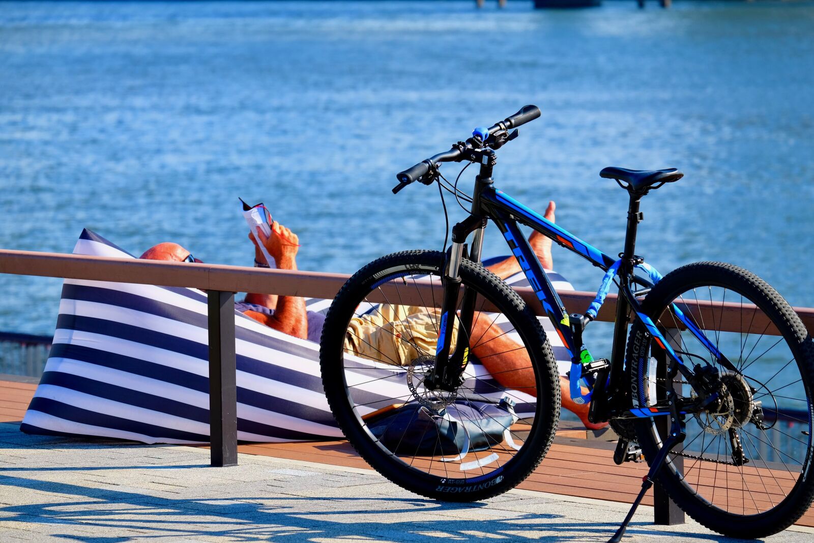 Fujifilm XF 55-200mm F3.5-4.8 R LM OIS sample photo. Waterside, sunbathing, book reading photography