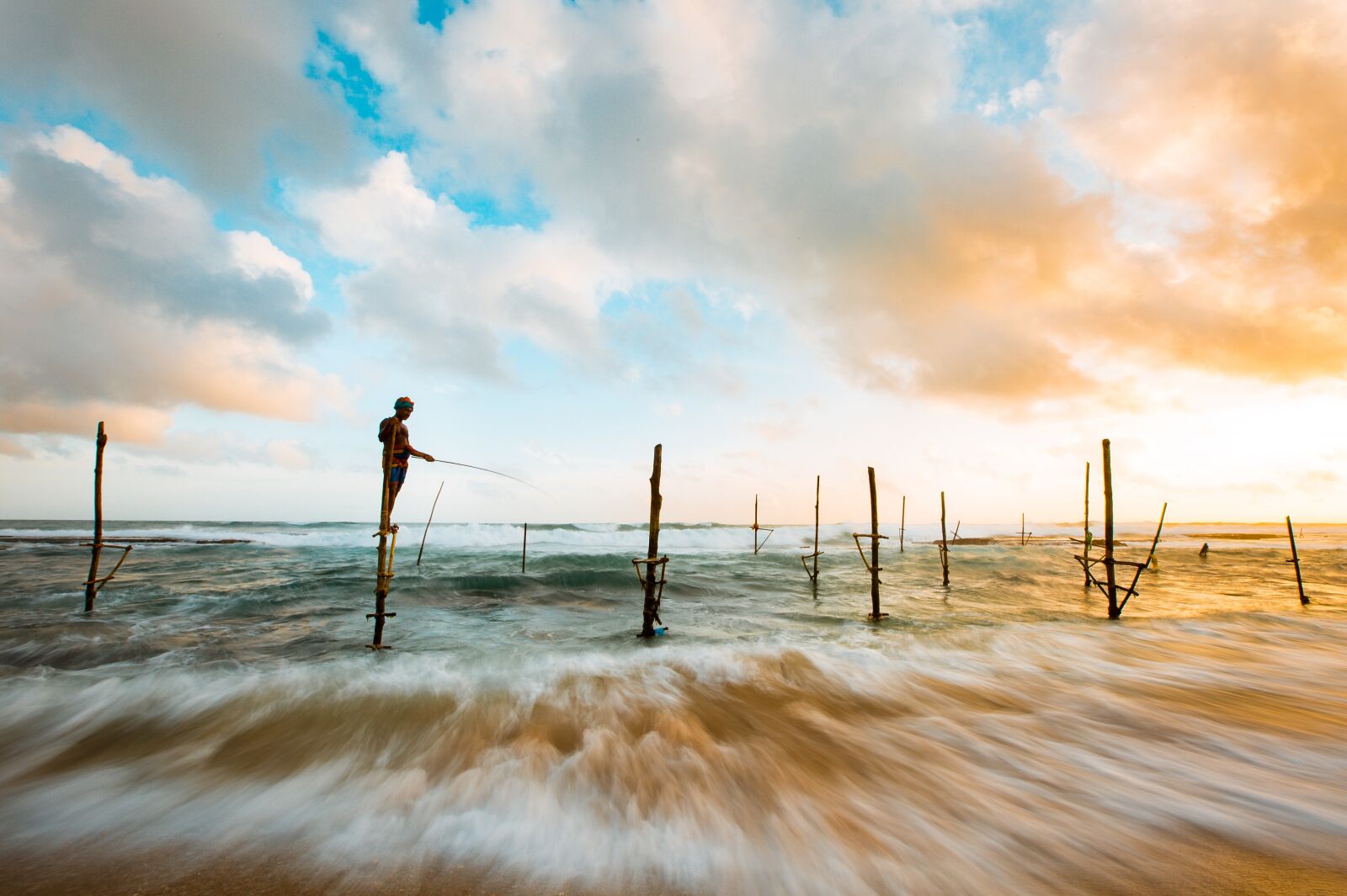 Canon EF 16-35mm F2.8L II USM sample photo. Beach, clouds, fishing photography