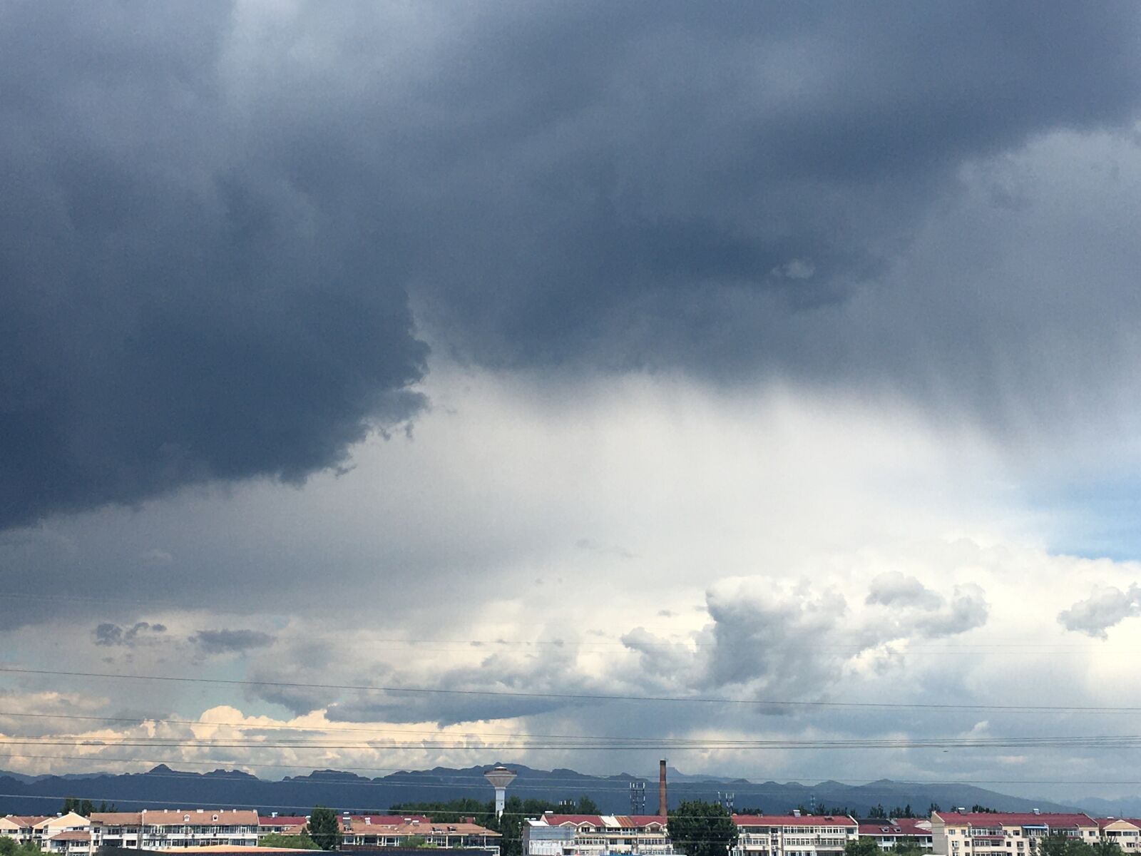 iPhone 6s Plus back camera 4.15mm f/2.2 sample photo. Dark clouds, distant hills photography