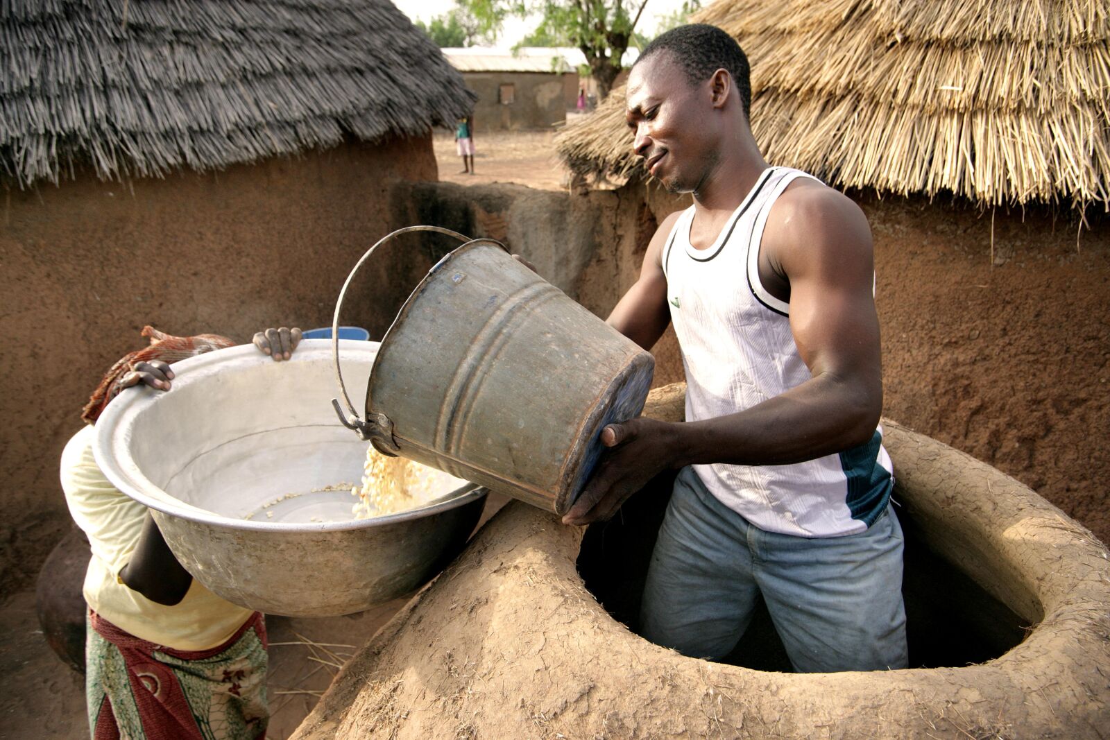 Canon EOS-1Ds Mark II sample photo. Farmer, fetching, corn, mud photography