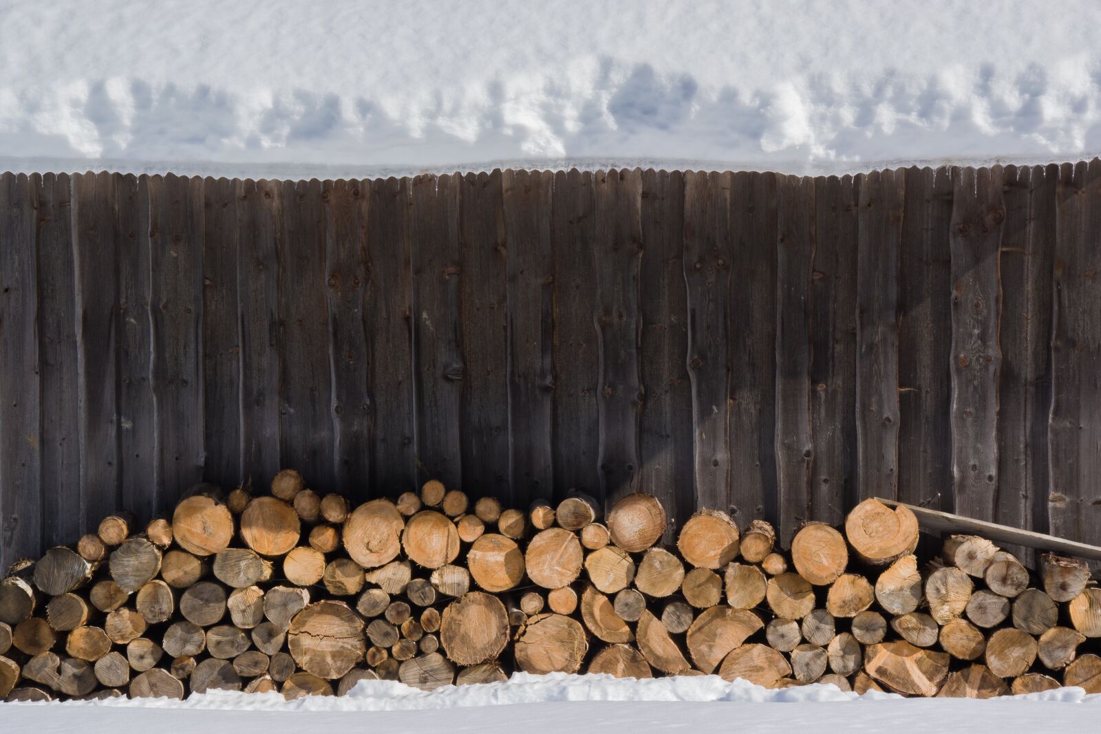Pentax K-70 sample photo. Snow, wood, stack photography