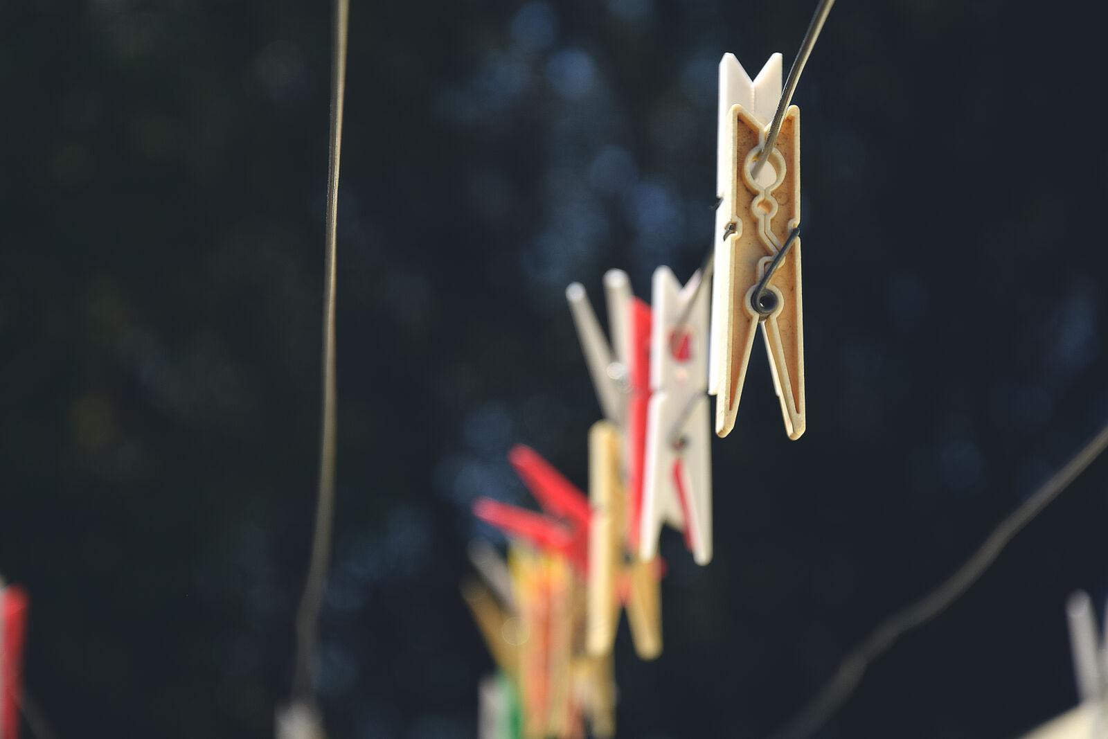AF Zoom-Nikkor 28-80mm f/3.3-5.6G sample photo. Colors, outdoors, hanging, clothespins photography