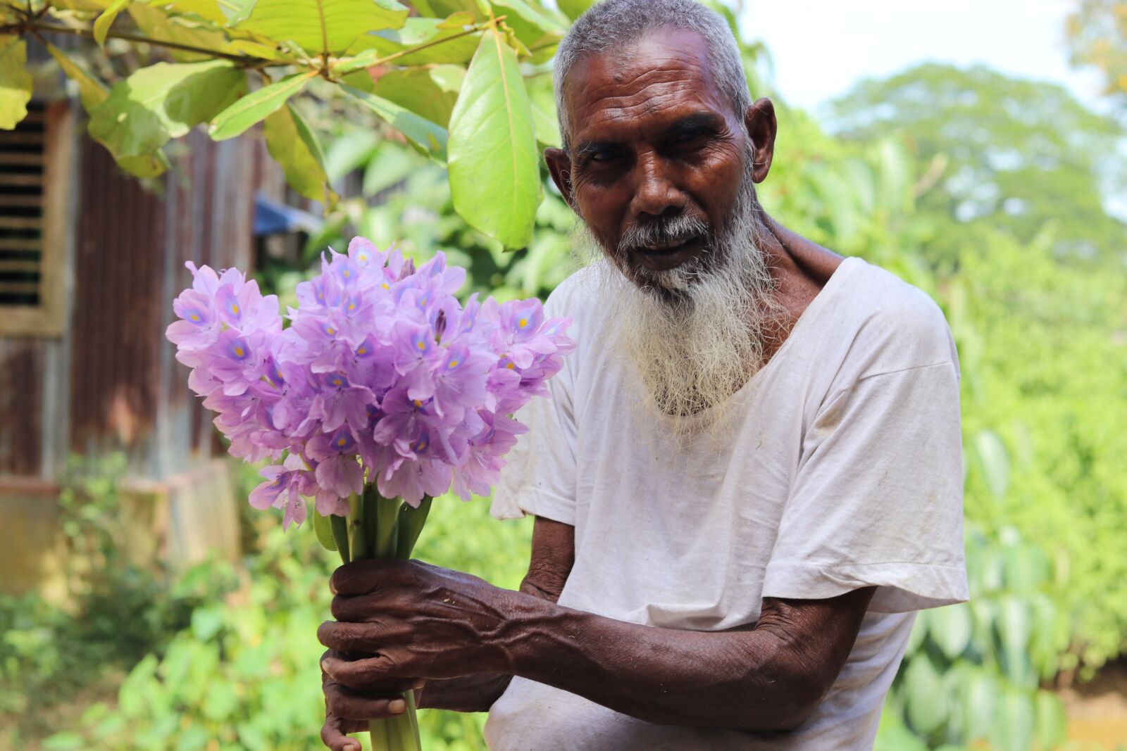 Canon EF 50mm F1.8 STM sample photo. Man, old, flowers photography