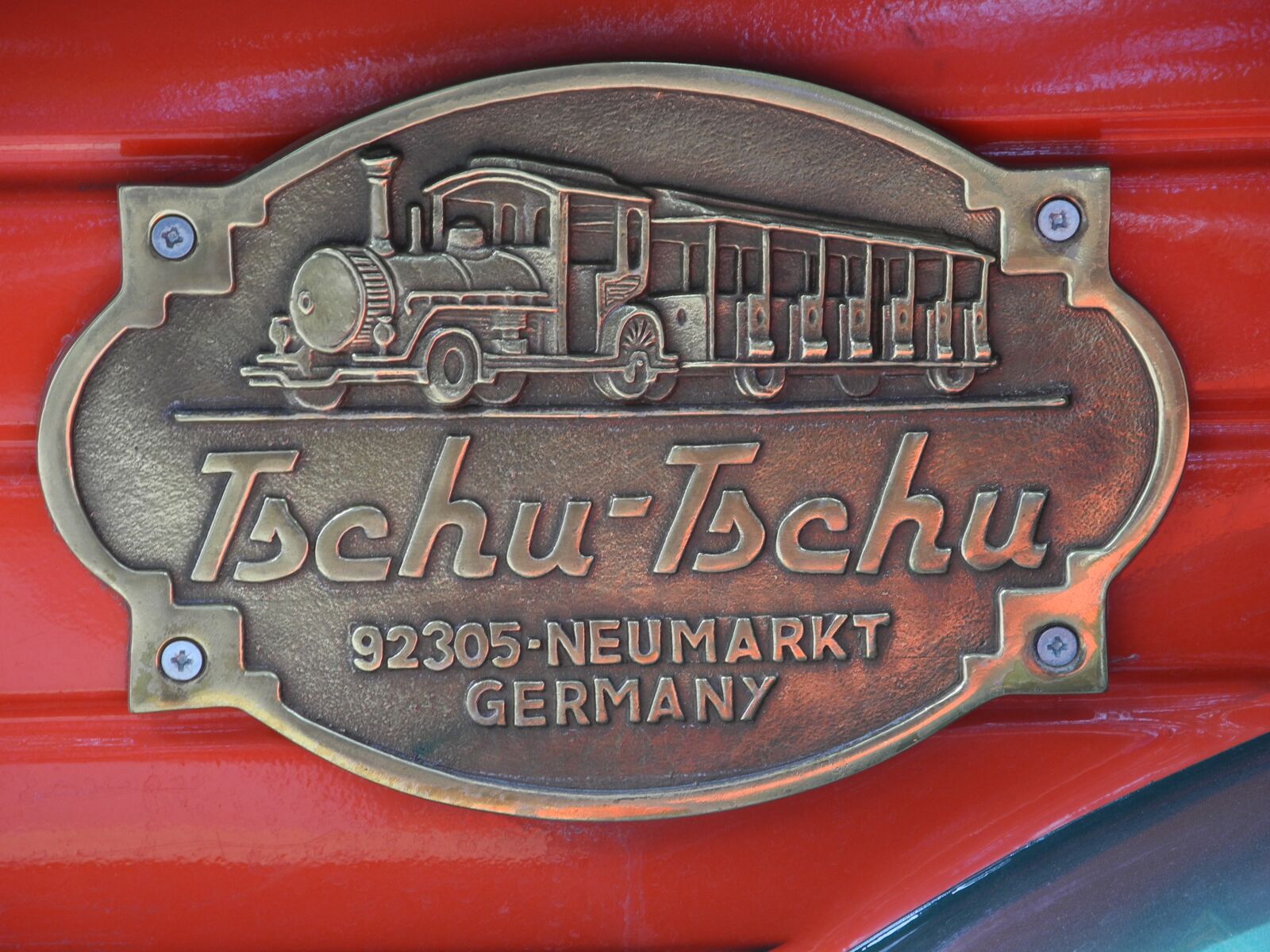 Nikon Coolpix P7000 sample photo. Brass plaque, train, golden photography