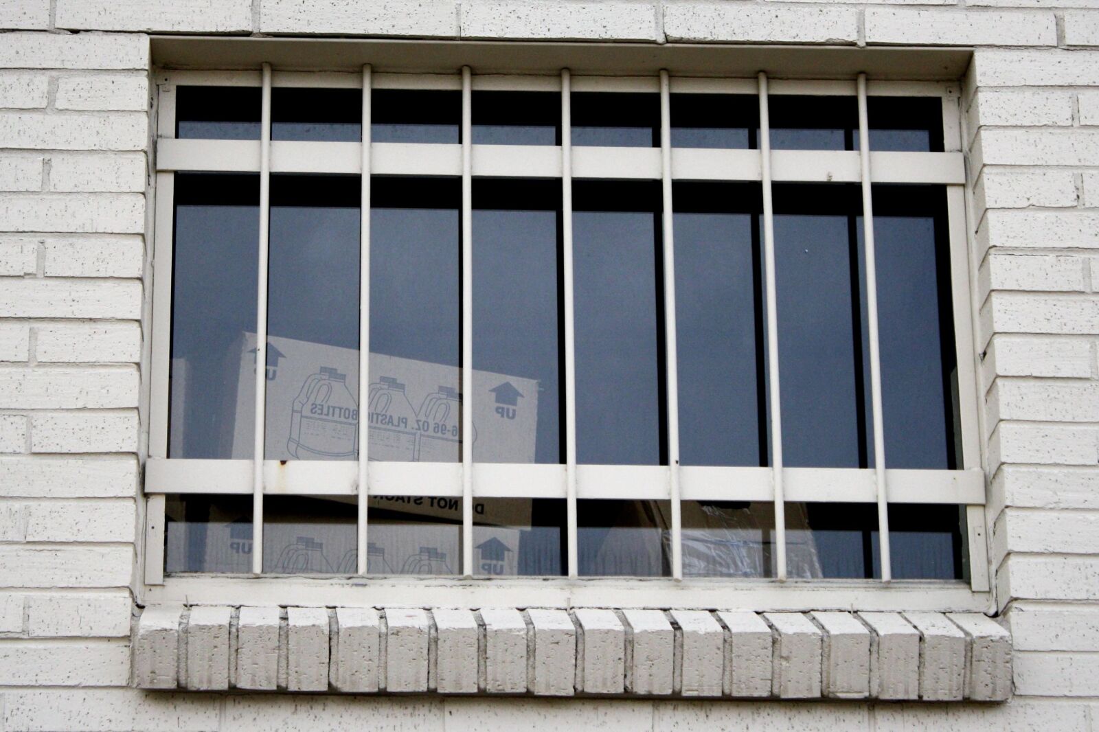 f/3.5-5.6 IS sample photo. Window, security bars, secure photography