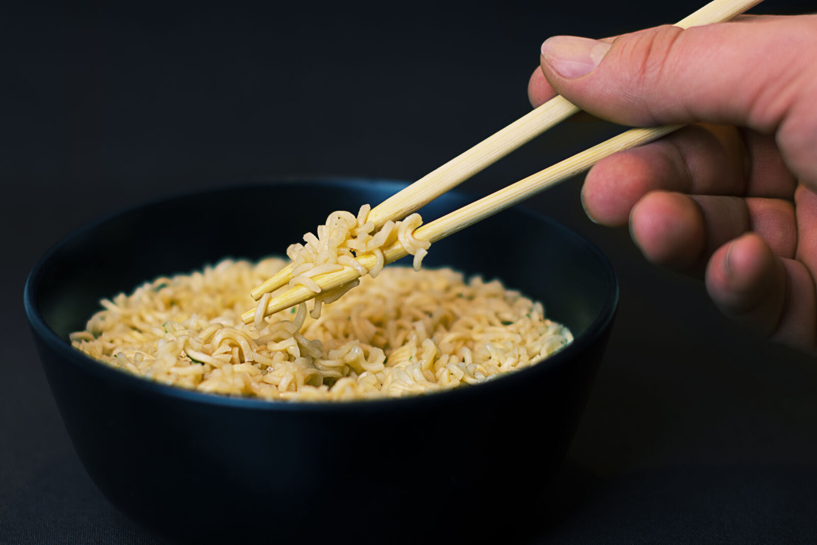 Nikon D5200 + Nikon AF-S Nikkor 50mm F1.4G sample photo. Person, holding, a, chopsticks photography