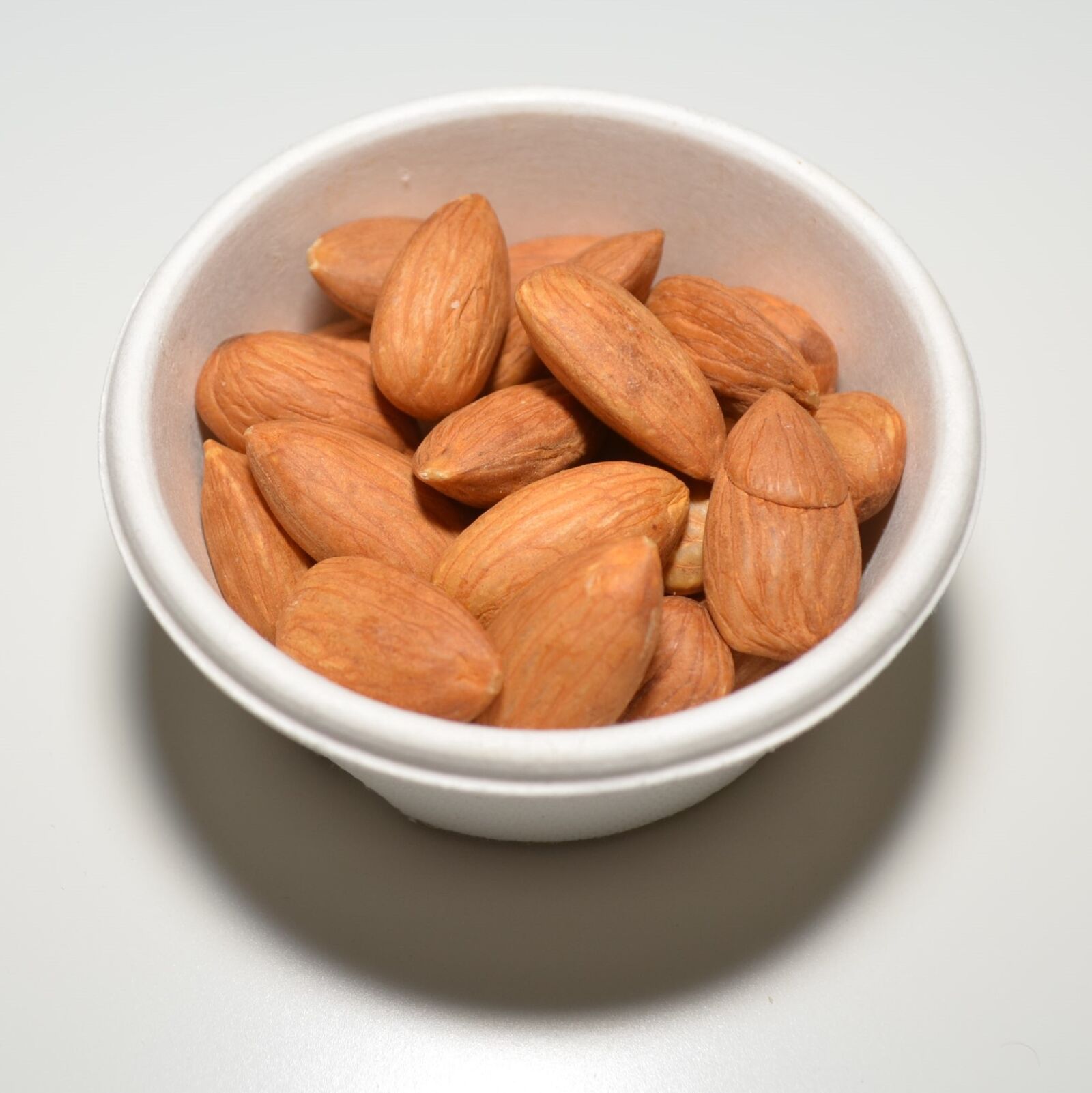 Nikon D5100 sample photo. Almonds, raw, cup photography