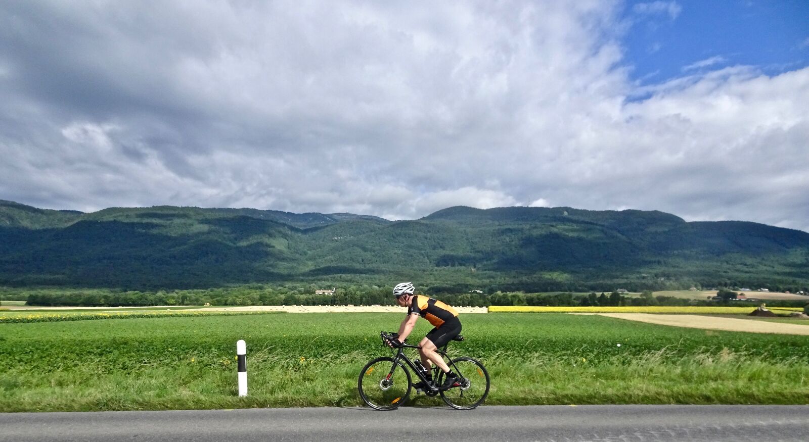 Sony Cyber-shot DSC-HX90V sample photo. Cyclist, outdoors, grass photography
