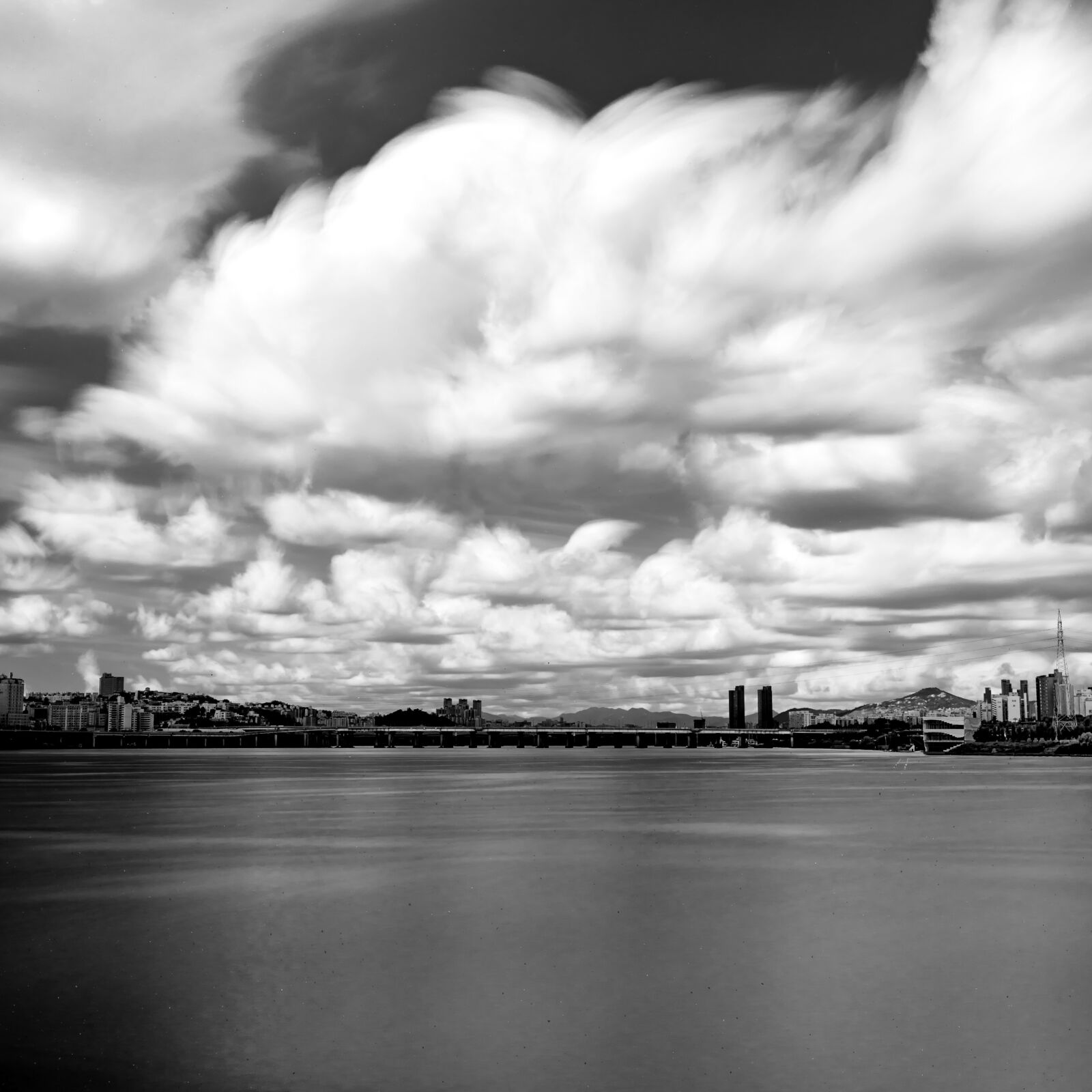 Sony a7 III + Sony Sonnar T* FE 35mm F2.8 ZA sample photo. Clouds, river, city photography