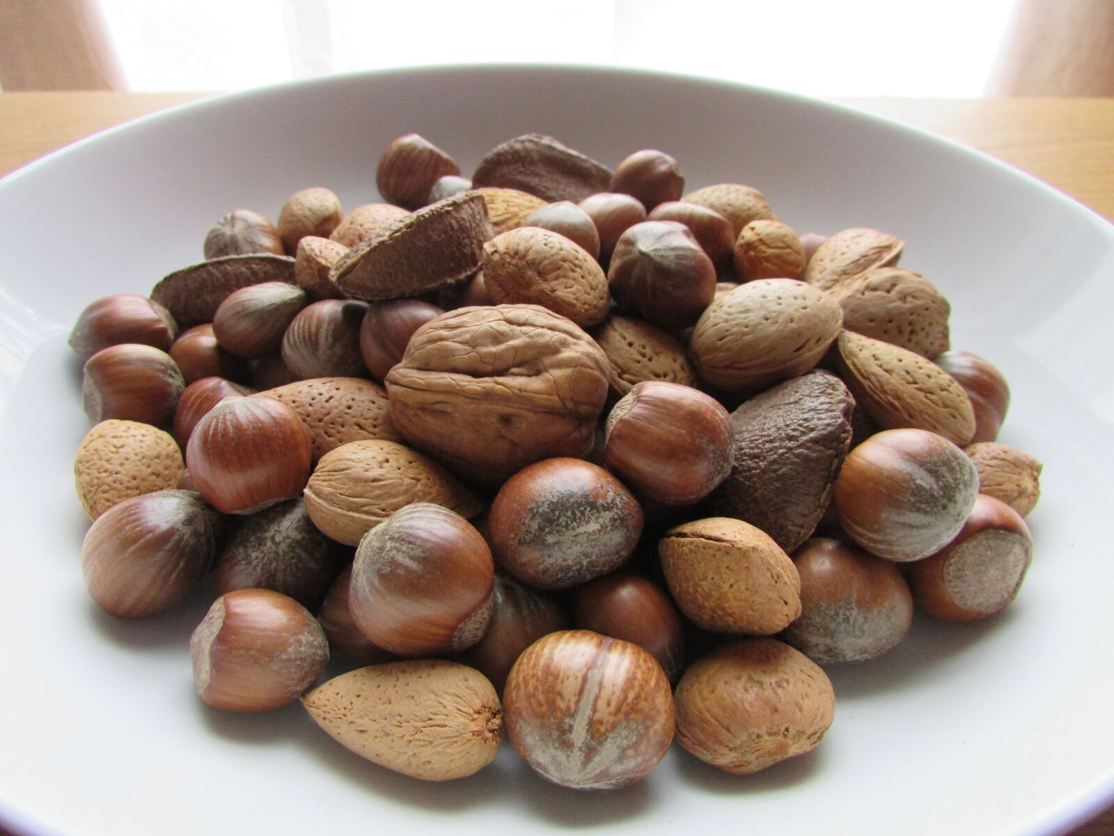 Canon PowerShot SX400 IS sample photo. Nuts in a bowl photography