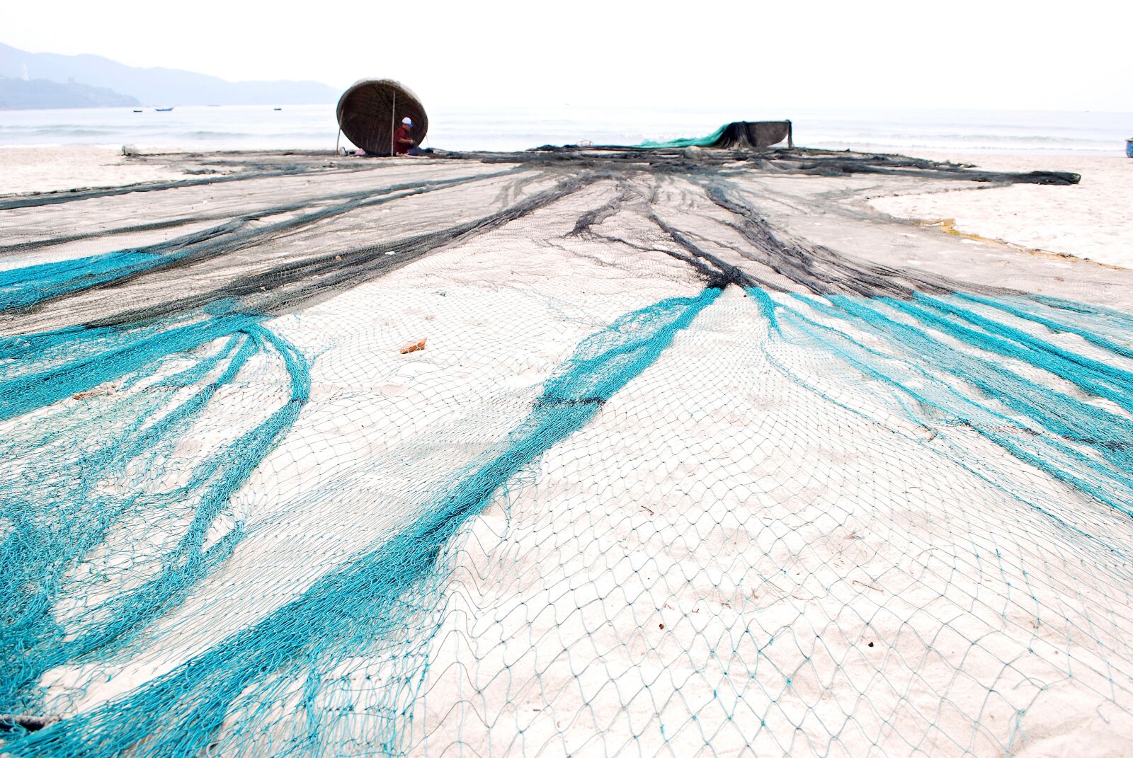 Nikon D60 sample photo. Mending their nets, the photography