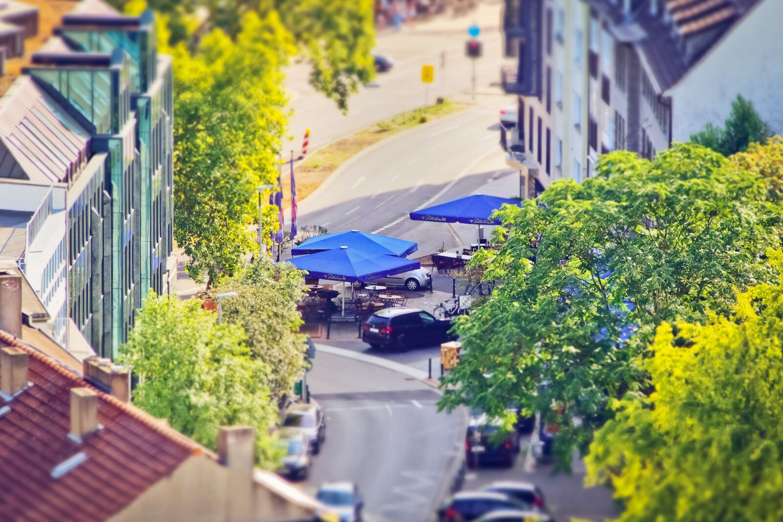 Olympus OM-D E-M10 sample photo. Road, parasols, city photography