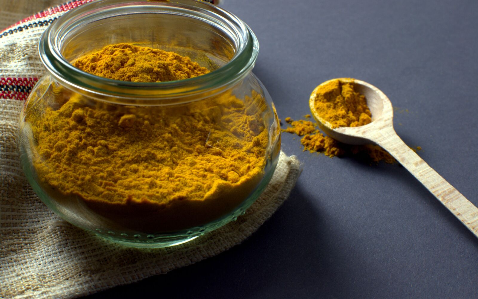 Nikon D3100 sample photo. Turmeric, manson jar, spoon photography