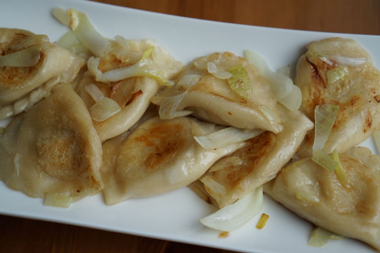 Sony a6000 + Sony E 35mm F1.8 OSS sample photo. Dumplings, pierogi ruskie, onion photography