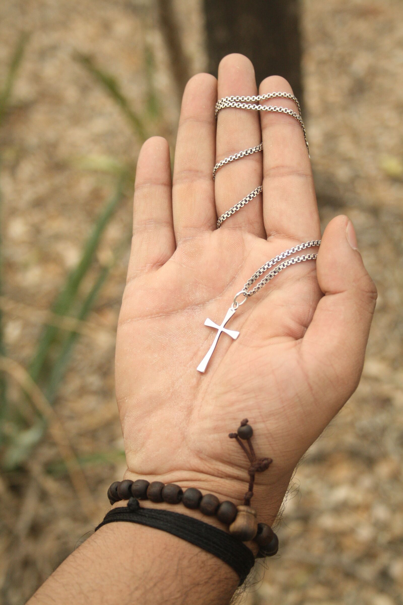 Canon EOS 1000D (EOS Digital Rebel XS / EOS Kiss F) sample photo. Hand, forest, cross photography