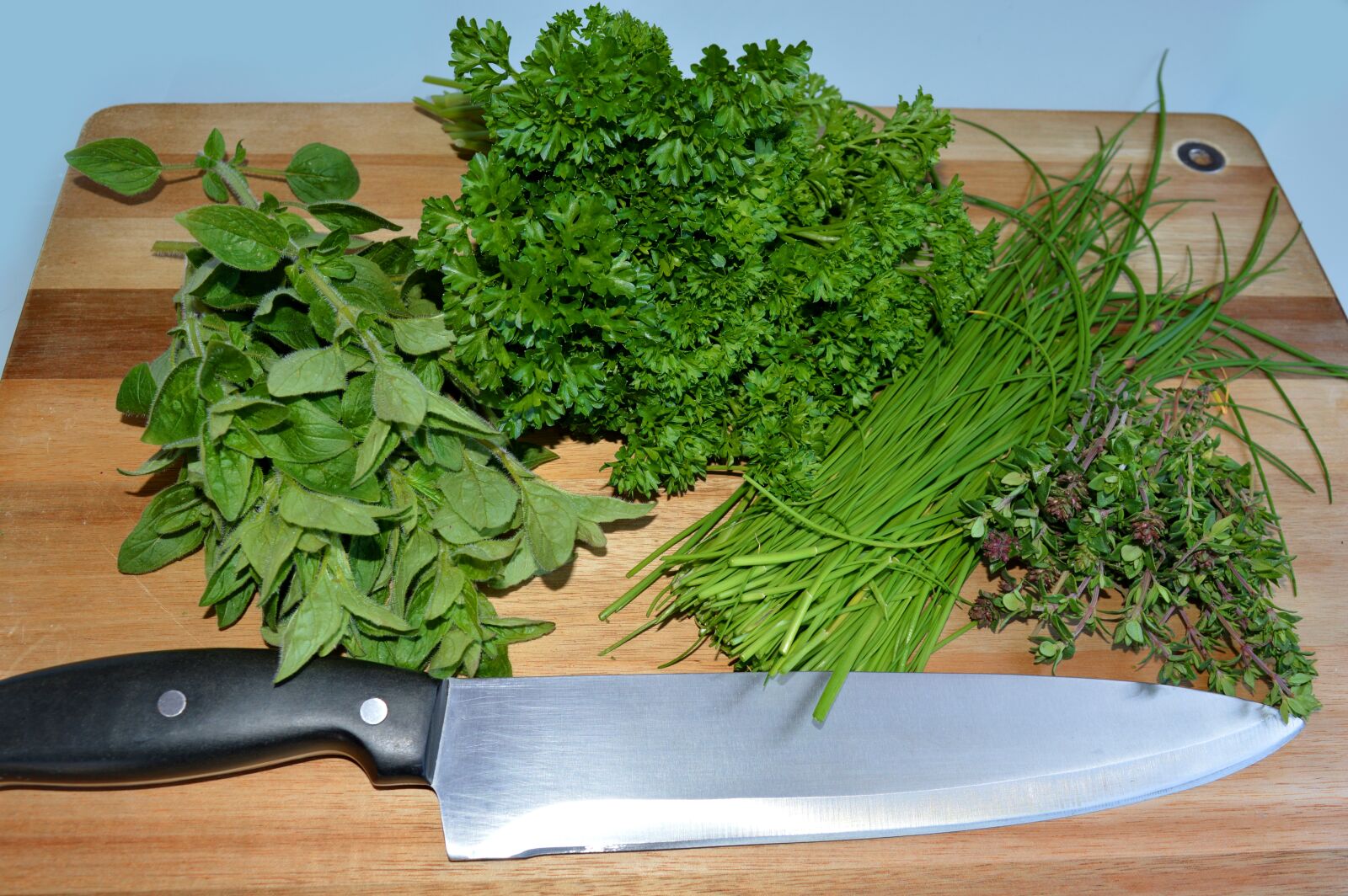 Nikon D3200 sample photo. Herbs, cutting board, knife photography