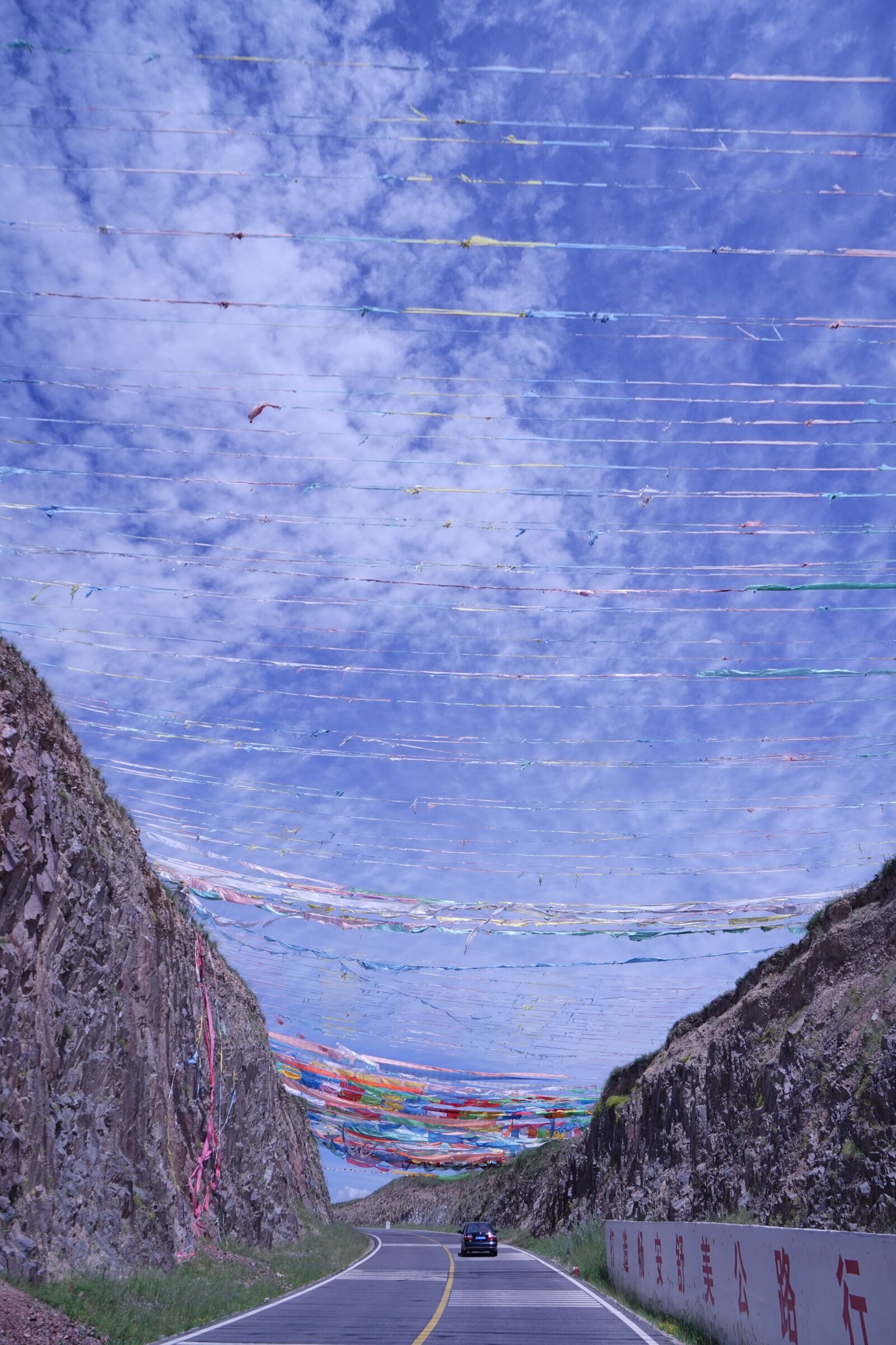 Sony a7 + Sony Vario Tessar T* FE 24-70mm F4 ZA OSS sample photo. Qinghai, prayer flags, pilgrimage photography