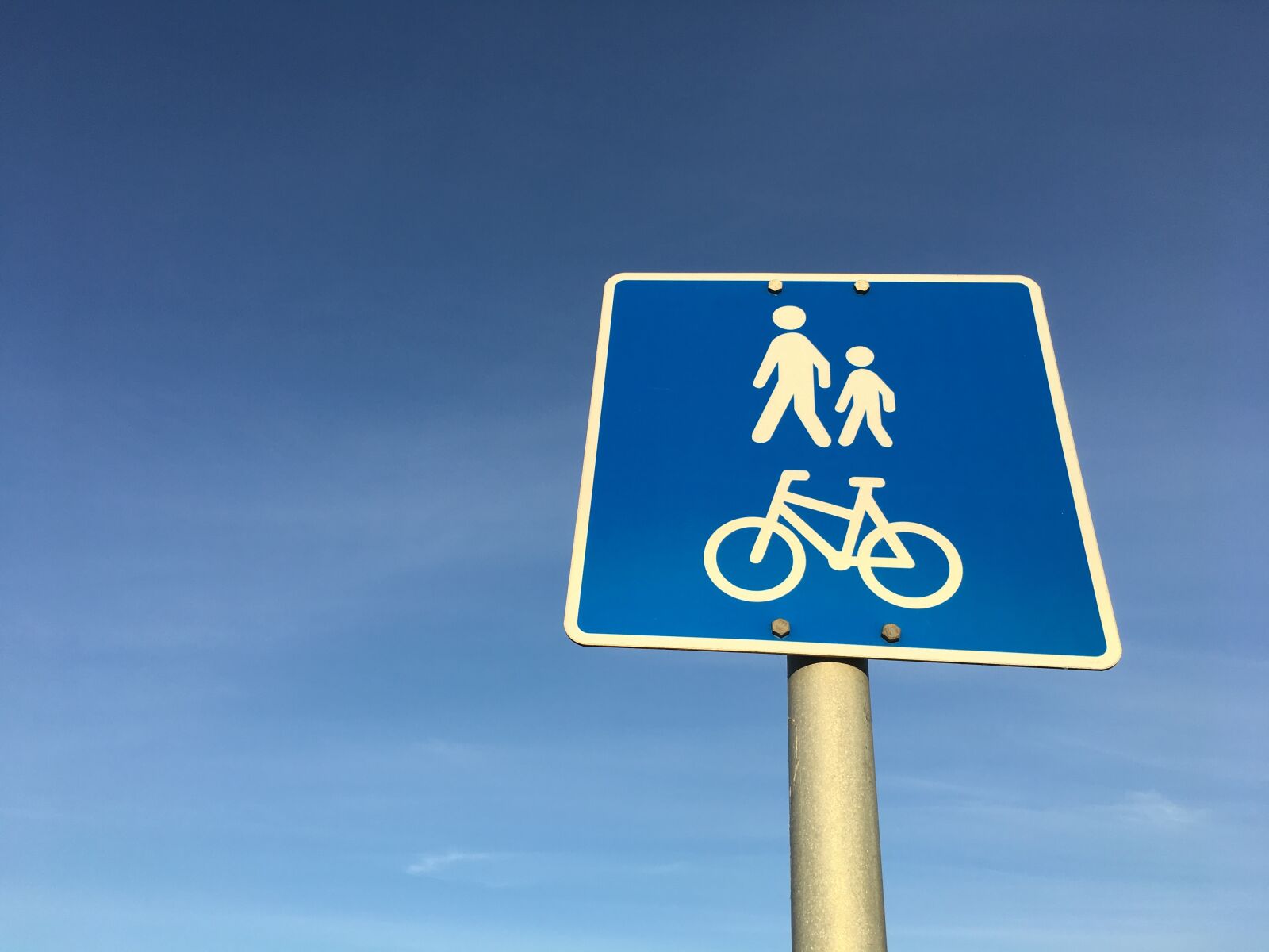 Apple iPhone 6s Plus sample photo. Road sign, pedestrian, motorcyclist photography