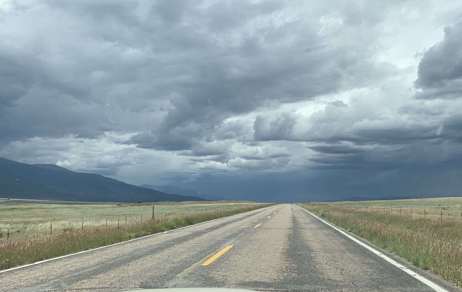 iPhone XR back camera 4.25mm f/1.8 sample photo. Storm, empty road, landscape photography