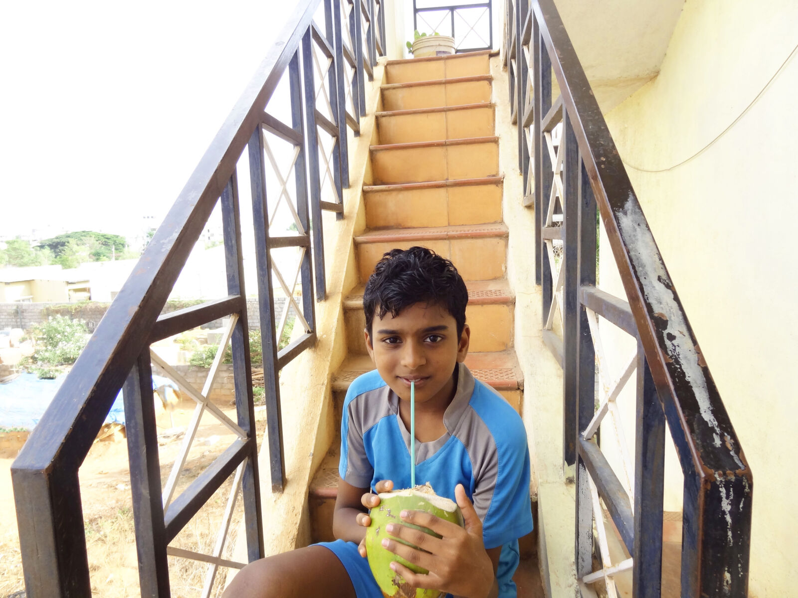 Sony Cyber-shot DSC-HX9V sample photo. Boy, sitting, and, holding photography