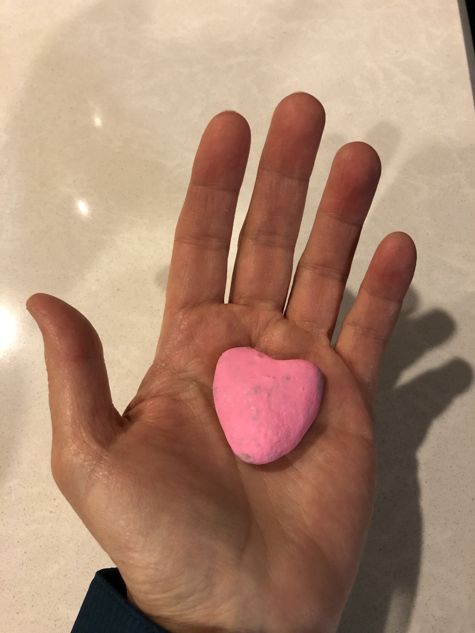 iPhone X back dual camera 4mm f/1.8 sample photo. Heart rock, hand, love photography