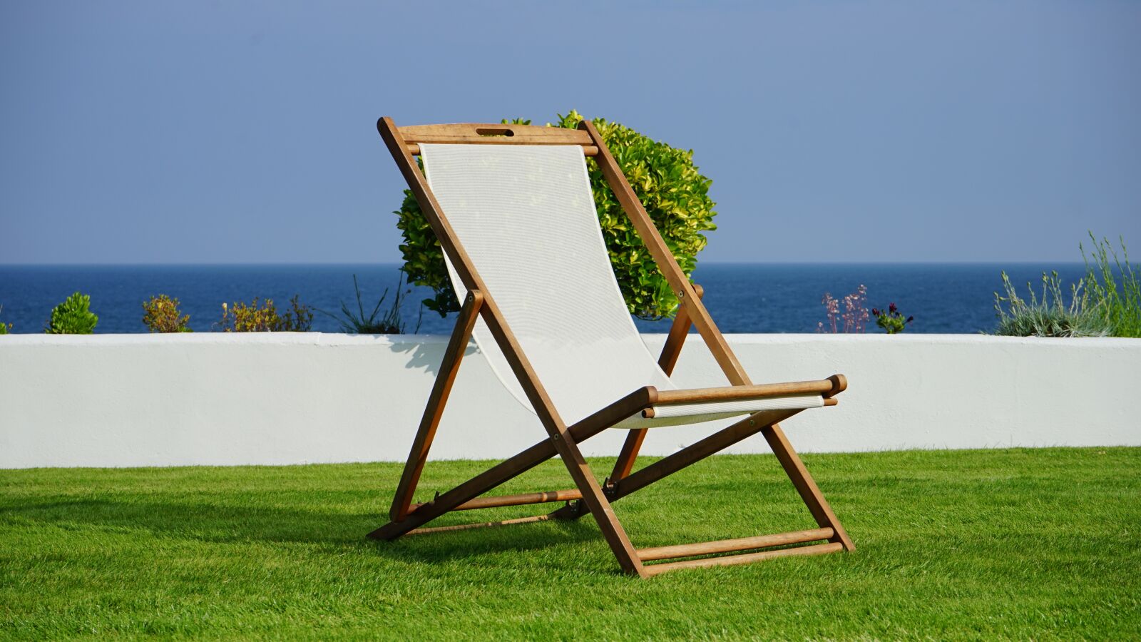Sony MODEL-NAME + Sony FE 28-70mm F3.5-5.6 OSS sample photo. Deck chair, grass, deck photography