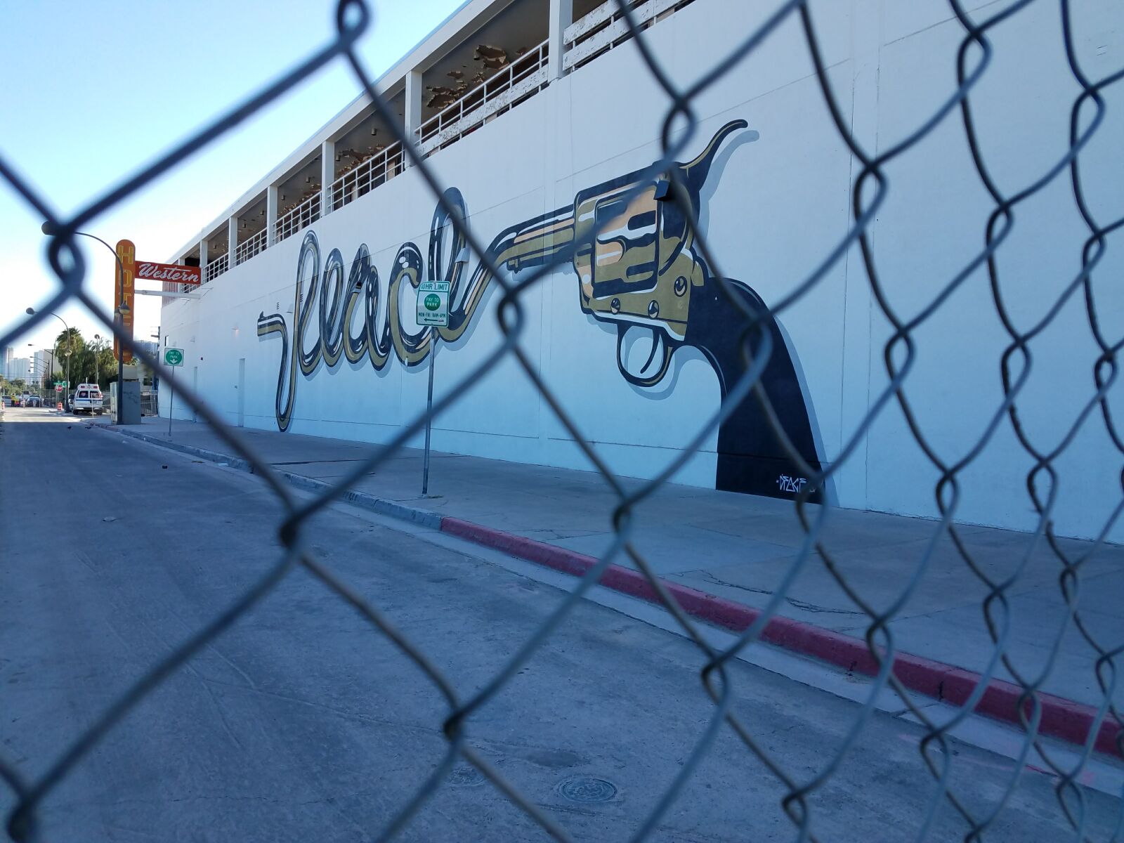 Samsung Galaxy S7 sample photo. Art, fence, graffiti, gun photography