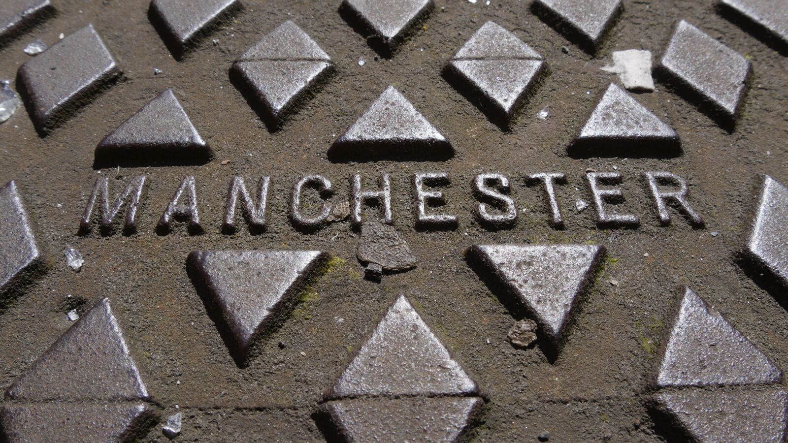 Panasonic Lumix DMC-GH4 sample photo. Manchester, manhole cover, metal photography
