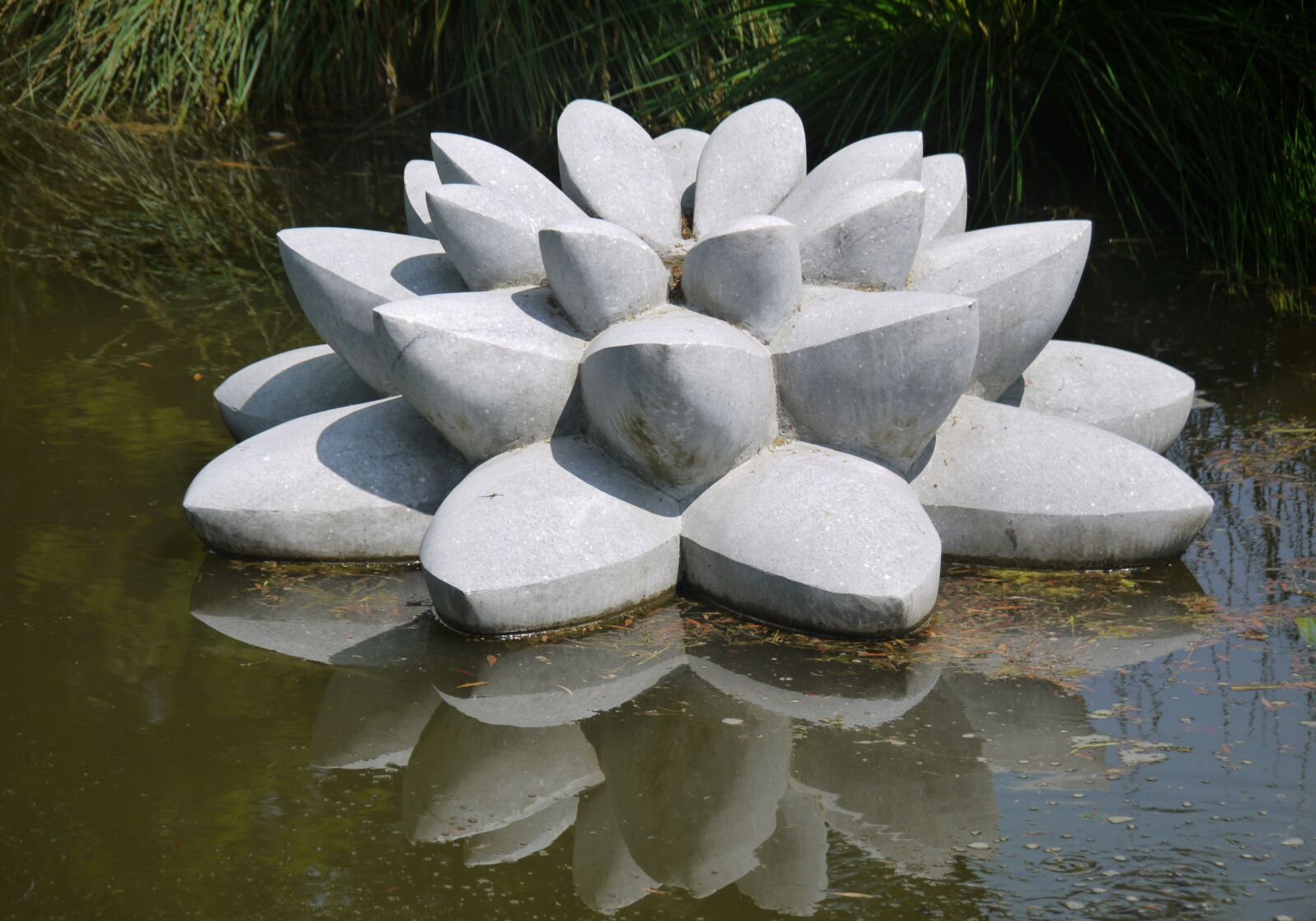 Panasonic Lumix DMC-G1 sample photo. Water lily, stone, sculpture photography