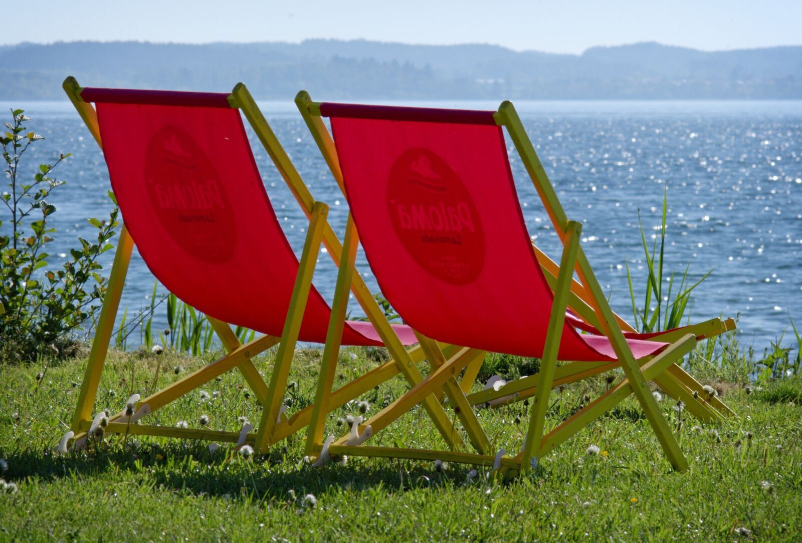 55.0-200.0mm f/4.0-f/5.6 sample photo. Deck chair, water, lake photography
