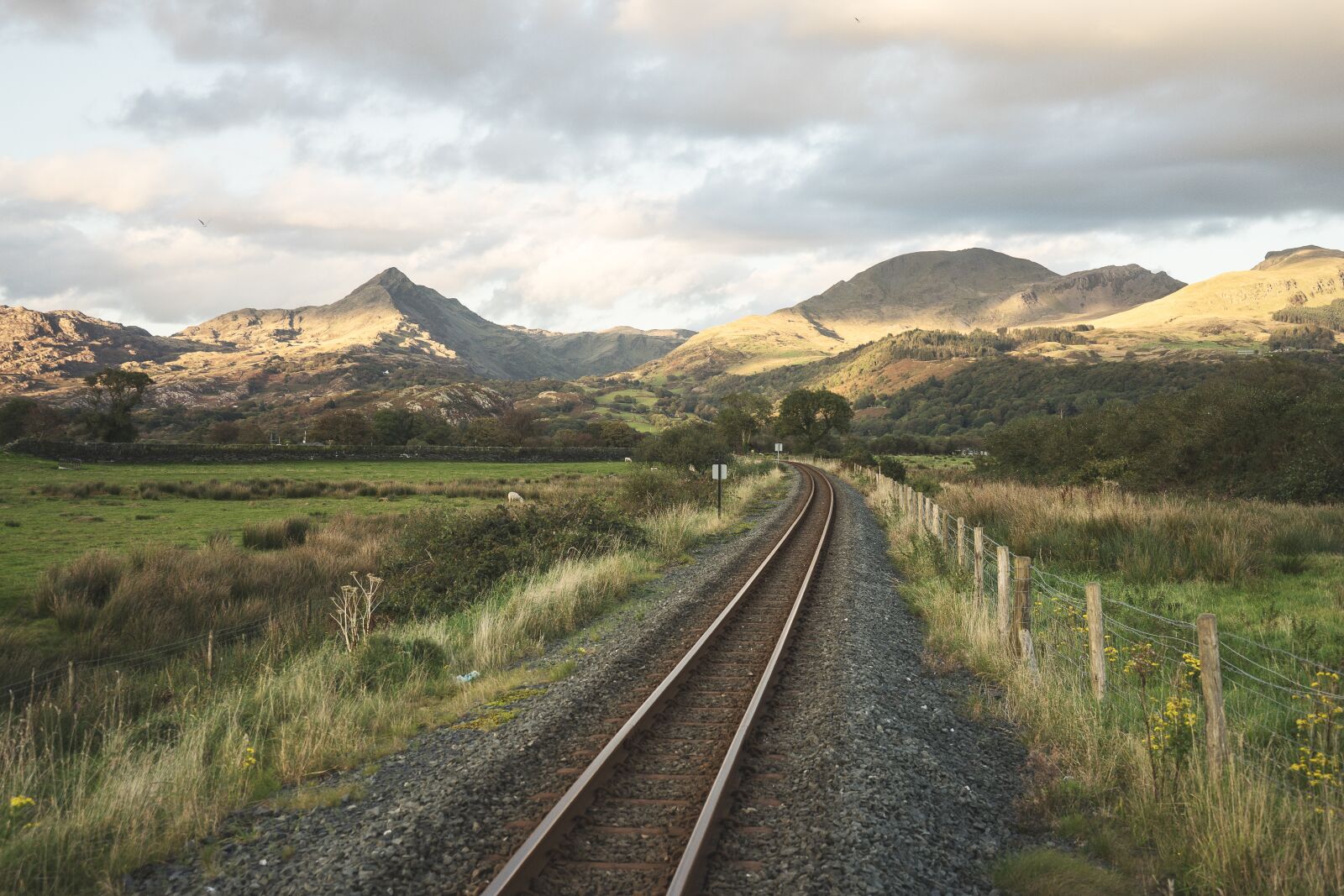 Sony a7 sample photo. Railroad, fence, mountains photography