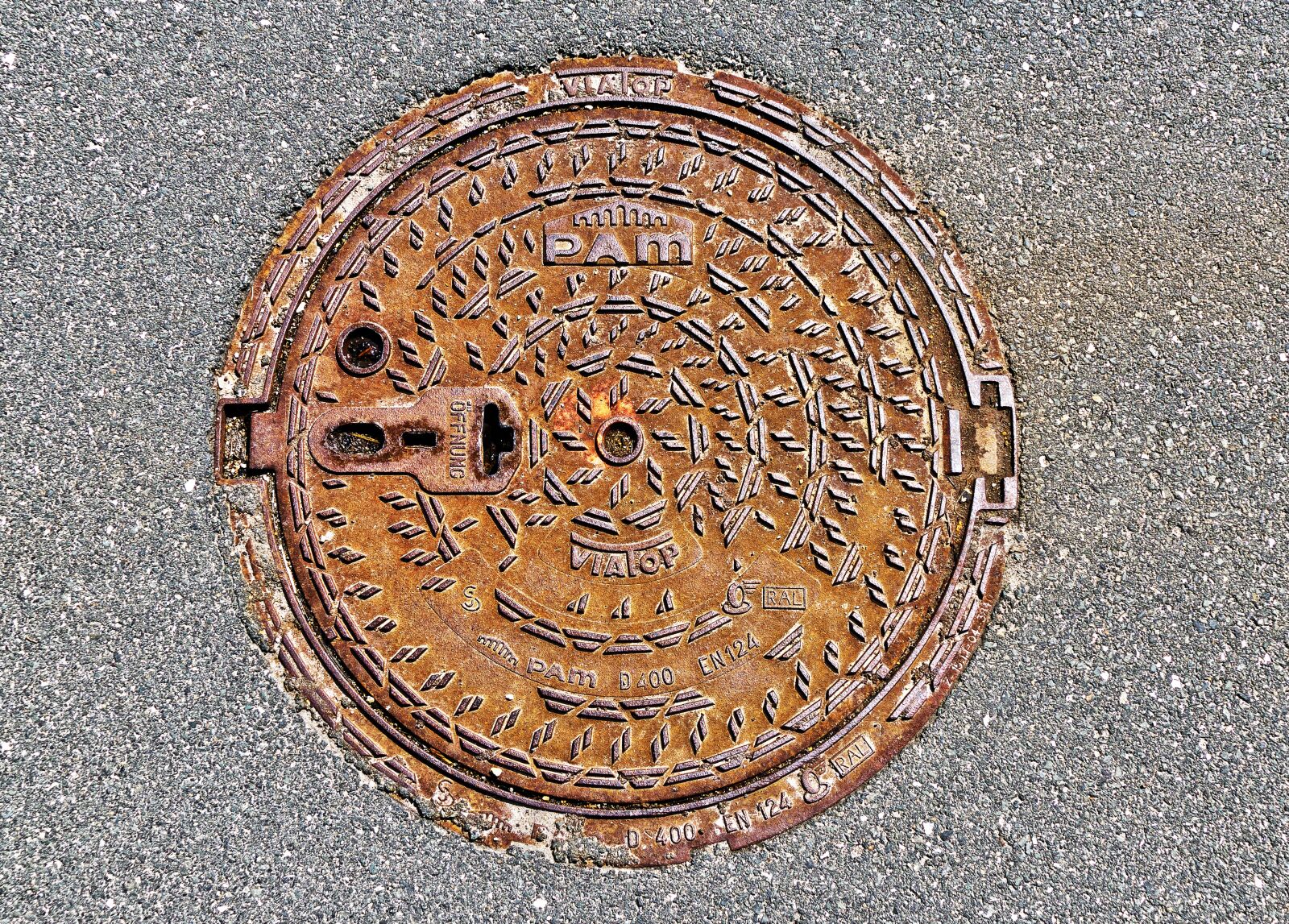 Panasonic Lumix DMC-FZ1000 sample photo. Manhole cover, rusty, asphalt photography