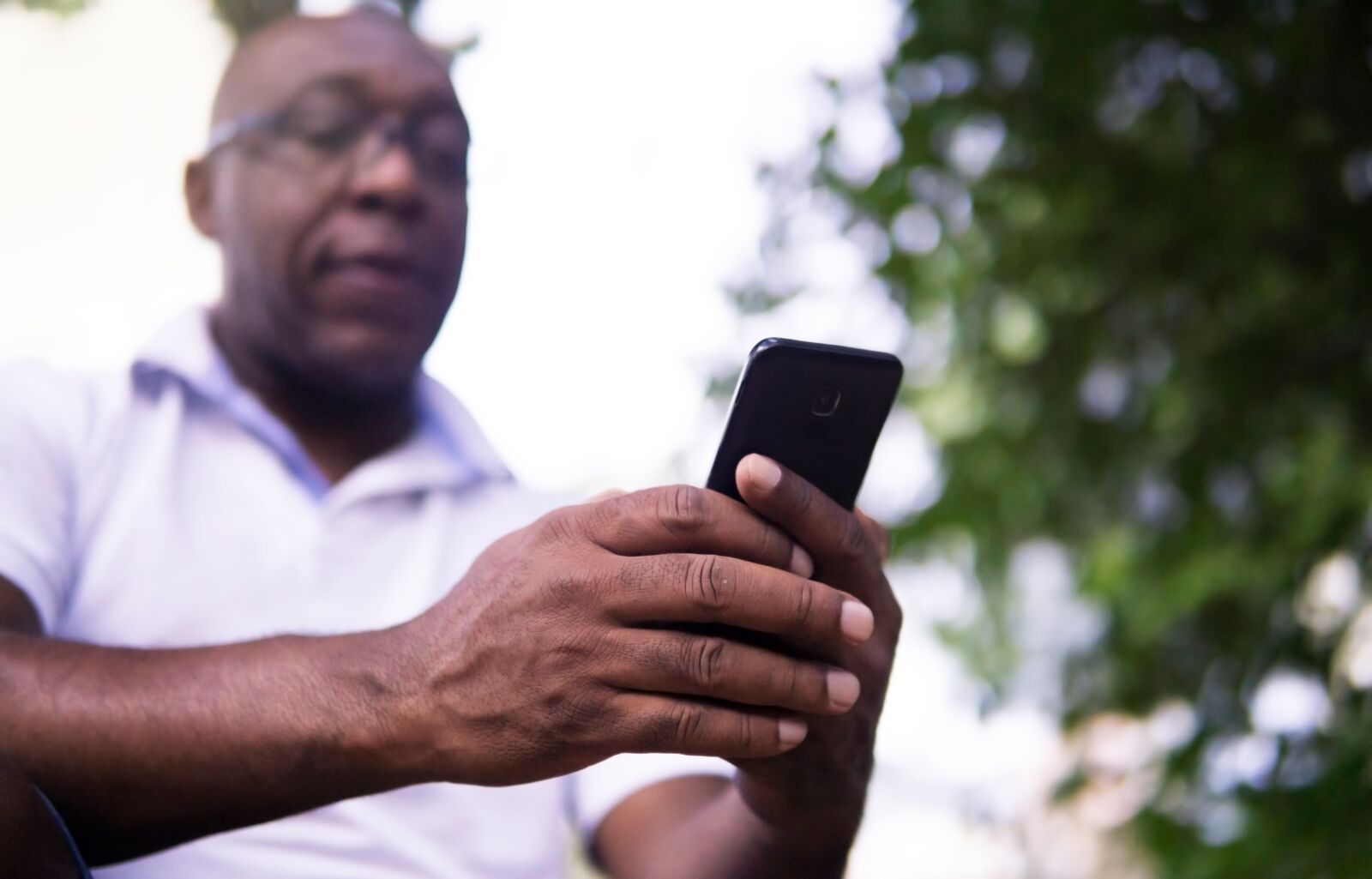 30mm F1.4 DC DN | Contemporary 016 sample photo. African american, cellphone, man photography