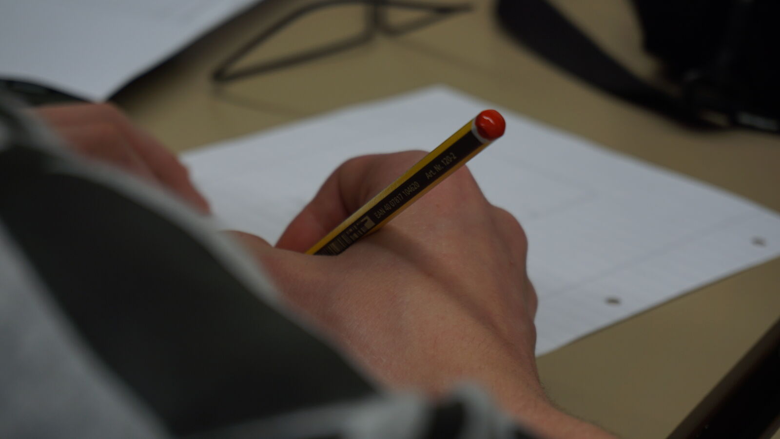 Sony a5100 sample photo. Desk, hands, paper, pencil photography