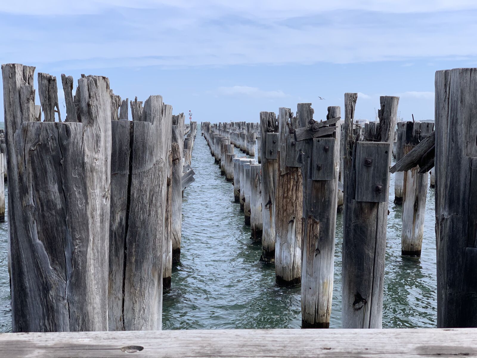 iPhone XS Max back dual camera 6mm f/2.4 sample photo. Pier, pylons, water photography