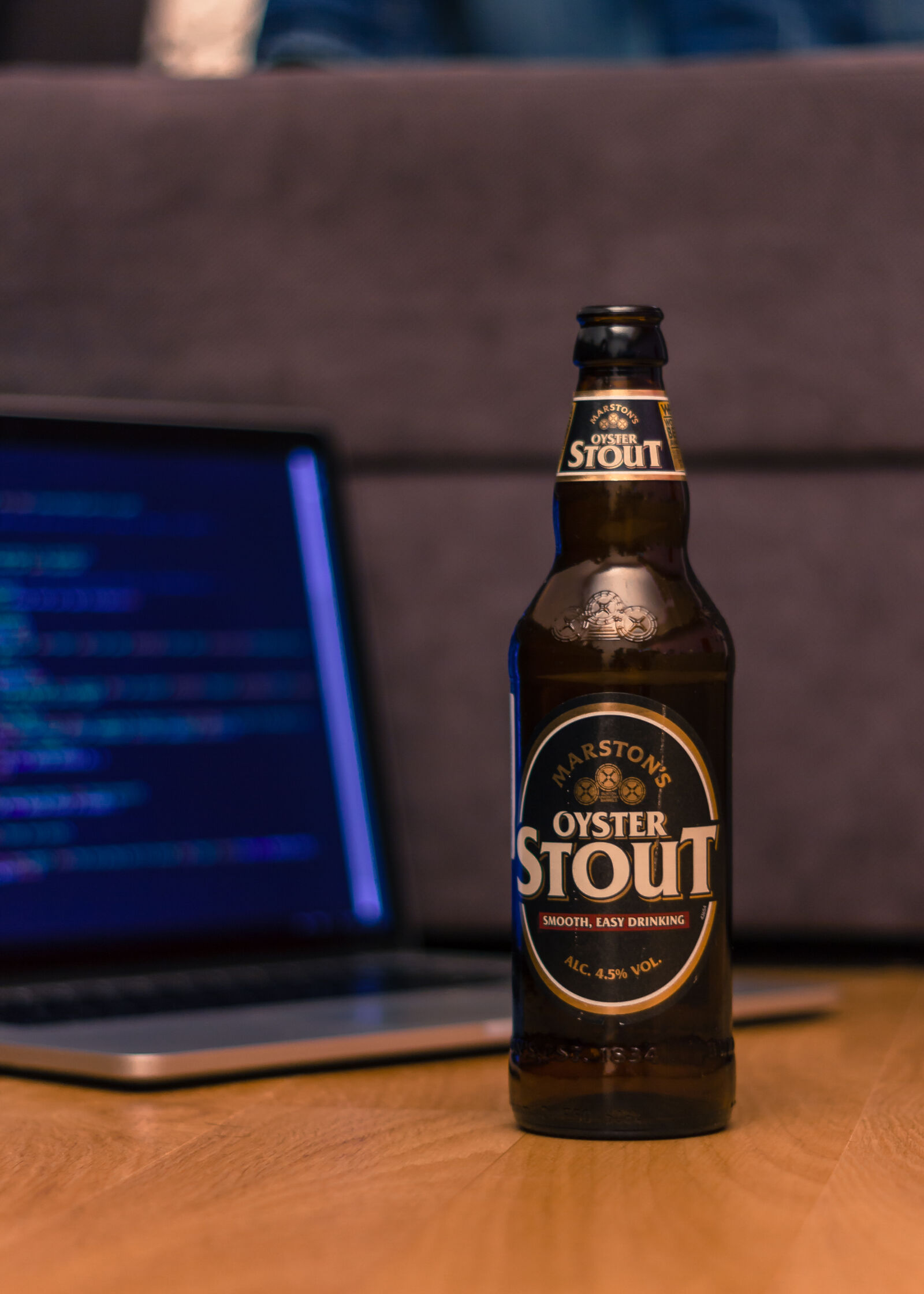 Canon EOS 550D (EOS Rebel T2i / EOS Kiss X4) + Canon EF 50mm F1.8 II sample photo. Beer, bottle, laptop, stout photography