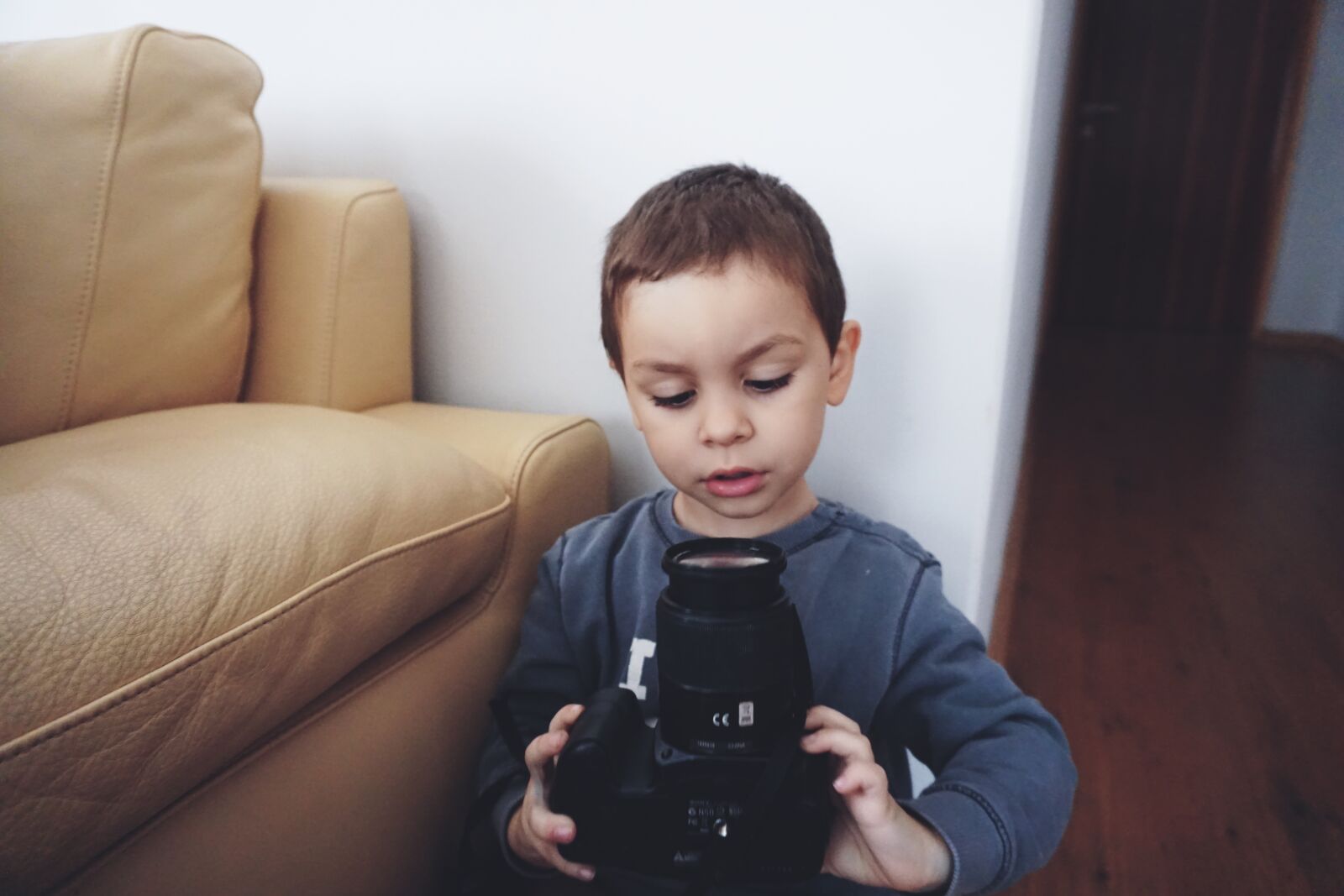 Sony E 16-50mm F3.5-5.6 PZ OSS sample photo. Boy, holding, black, dslr photography