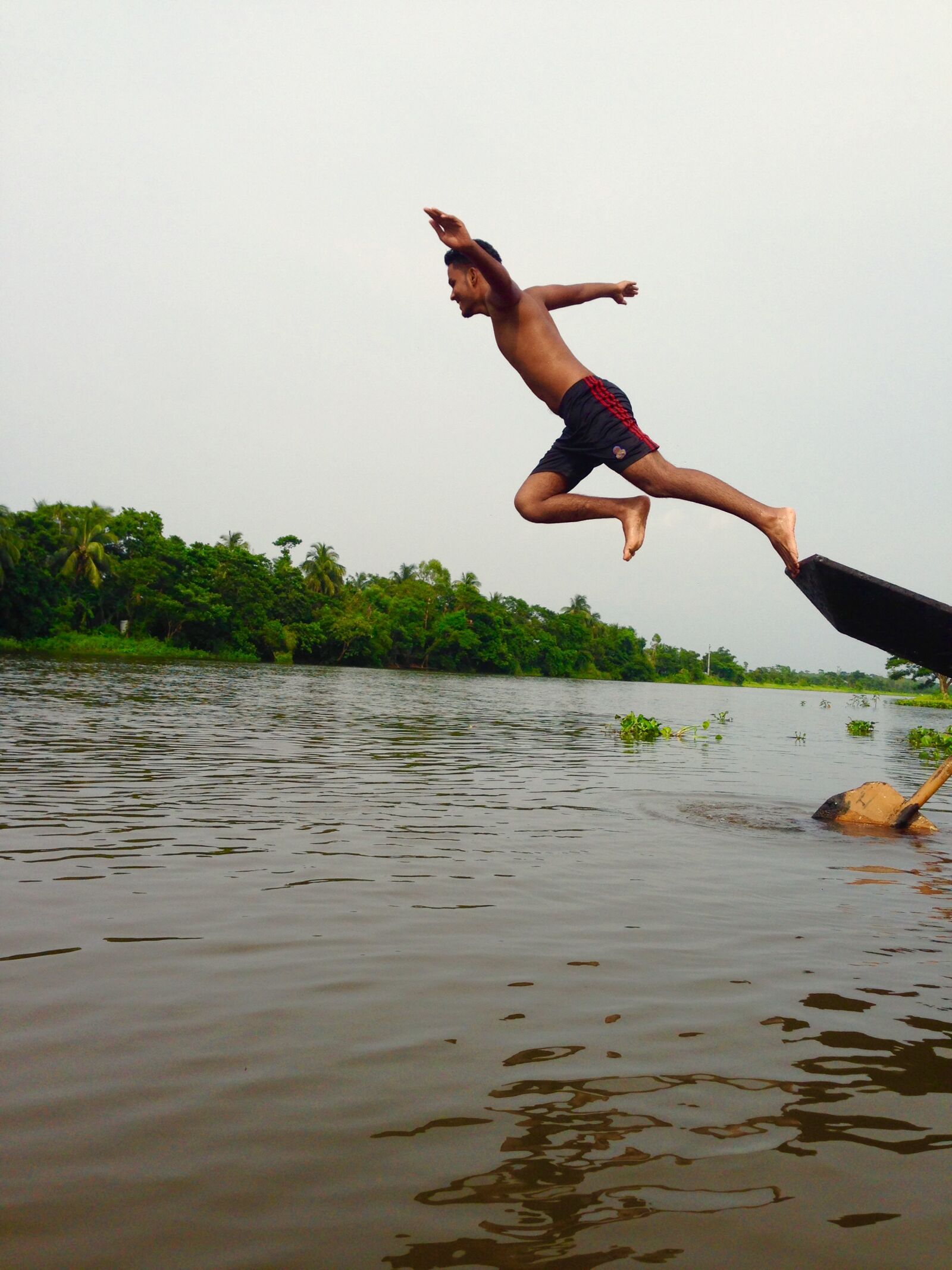 Apple iPhone 5 sample photo. Man, jump, pond photography