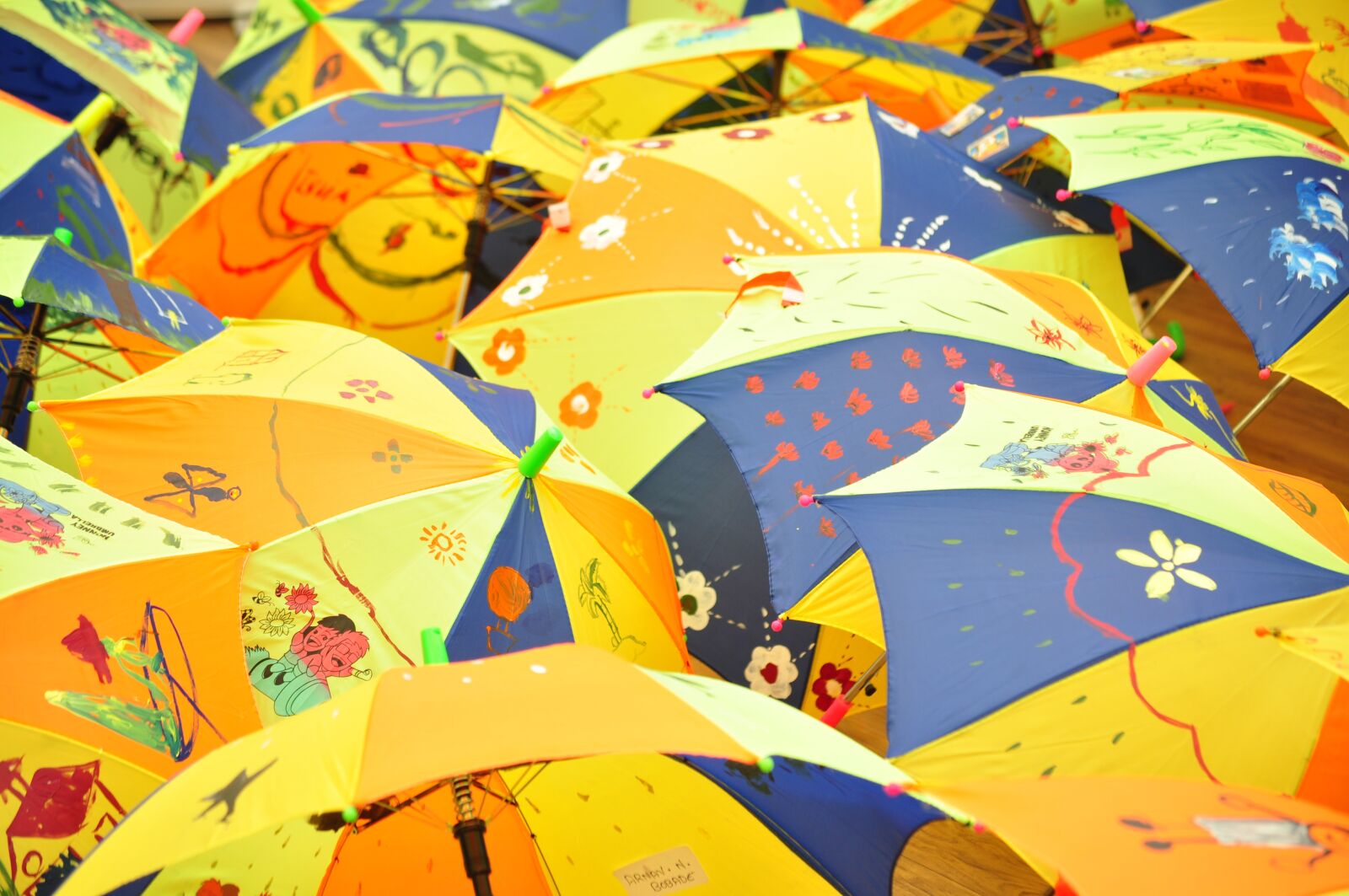 Nikon D5000 sample photo. Umbrellas, kids painting, colorful photography