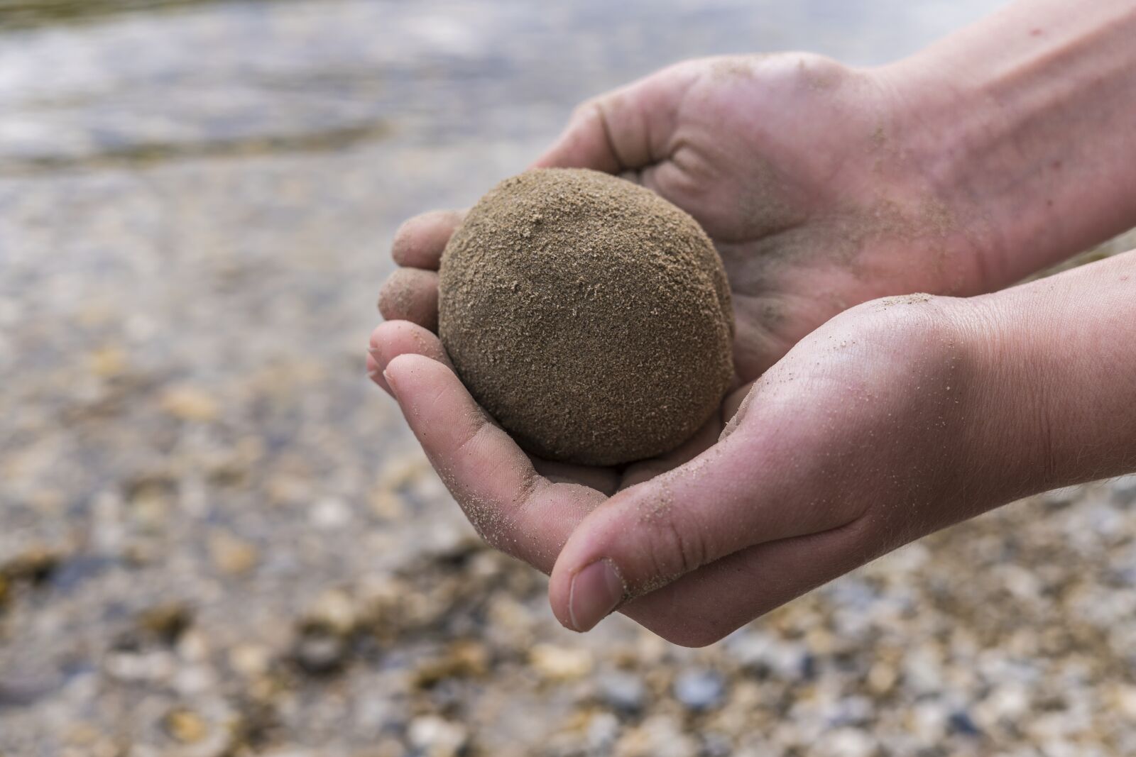 Sony a6300 + Sigma 30mm F2.8 EX DN sample photo. Sand ball, hands, child photography