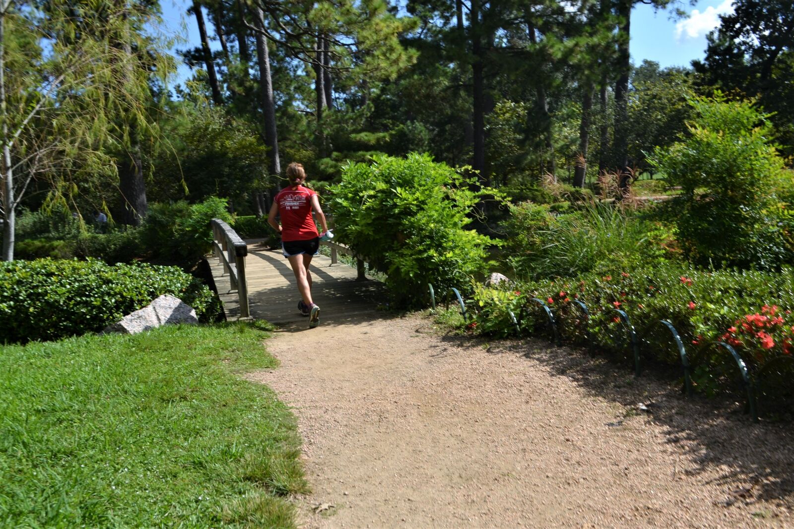 Nikon D3100 sample photo. Female jogger, running, green photography