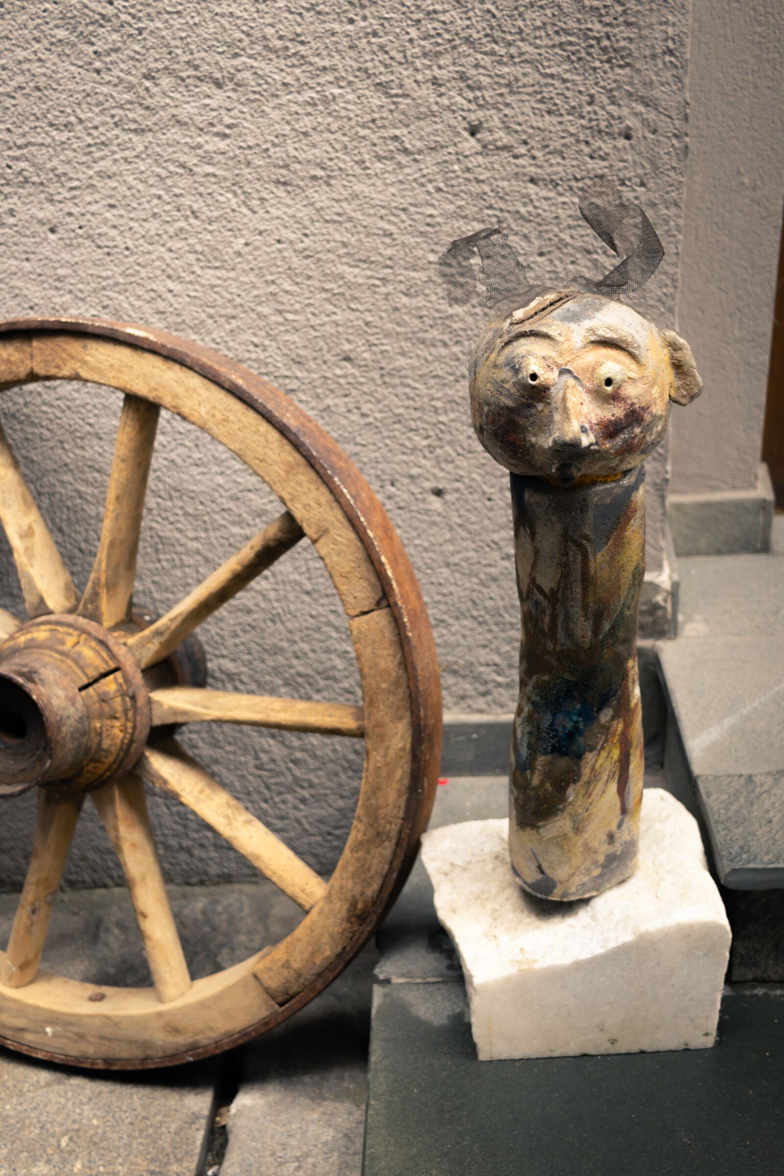 Canon EF-S 24mm F2.8 STM sample photo. Wooden wheel, wooden statue photography