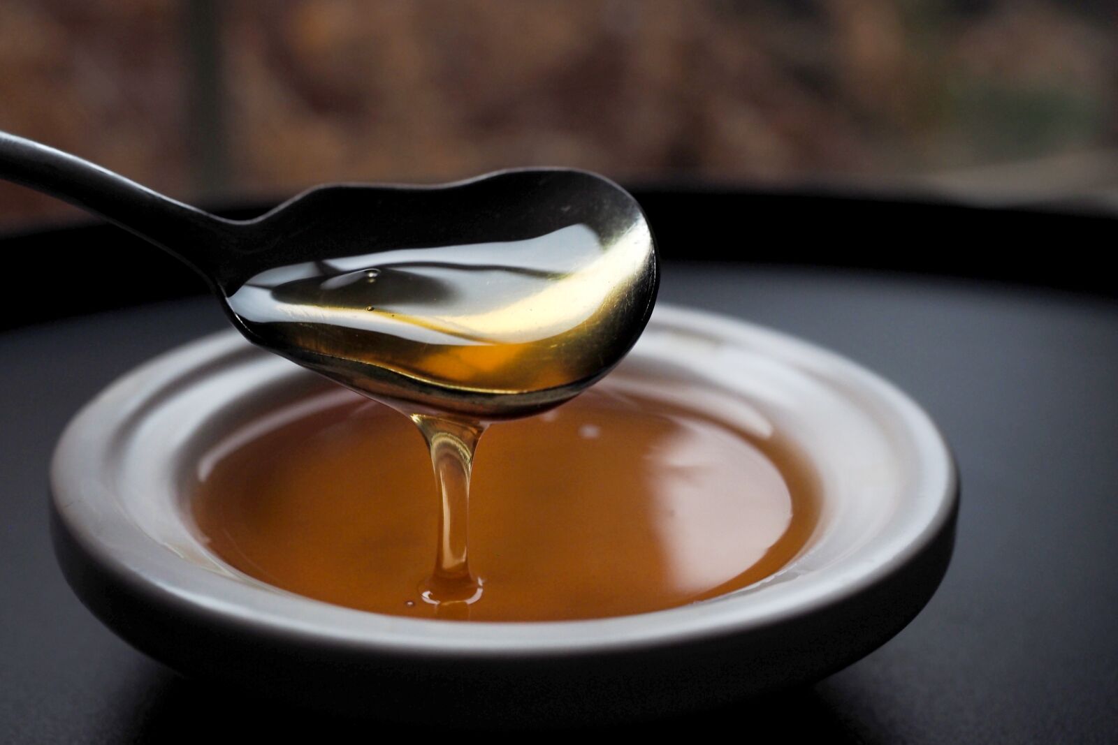 Olympus OM-D E-M1 + Olympus M.Zuiko Digital ED 12-40mm F2.8 Pro sample photo. Honey, spoon, food photography