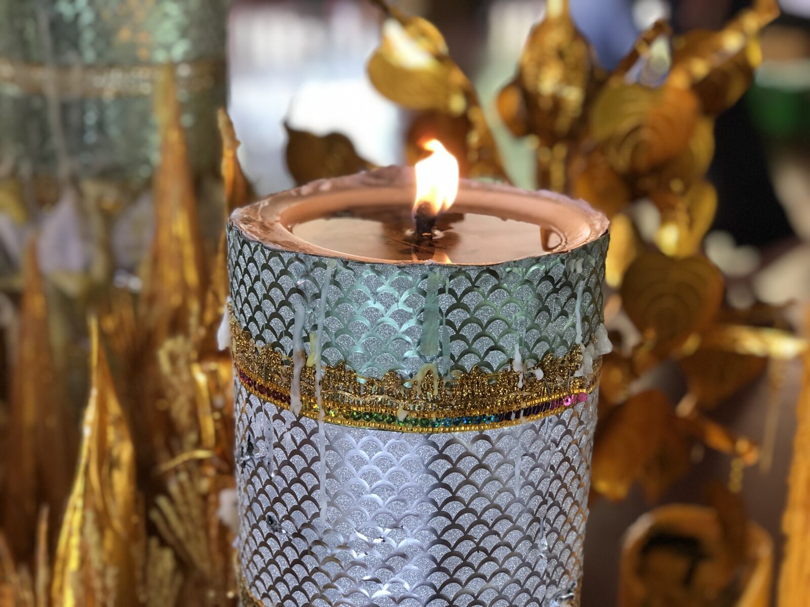 iPhone 8 Plus back dual camera 6.6mm f/2.8 sample photo. Candle, temple, gold photography