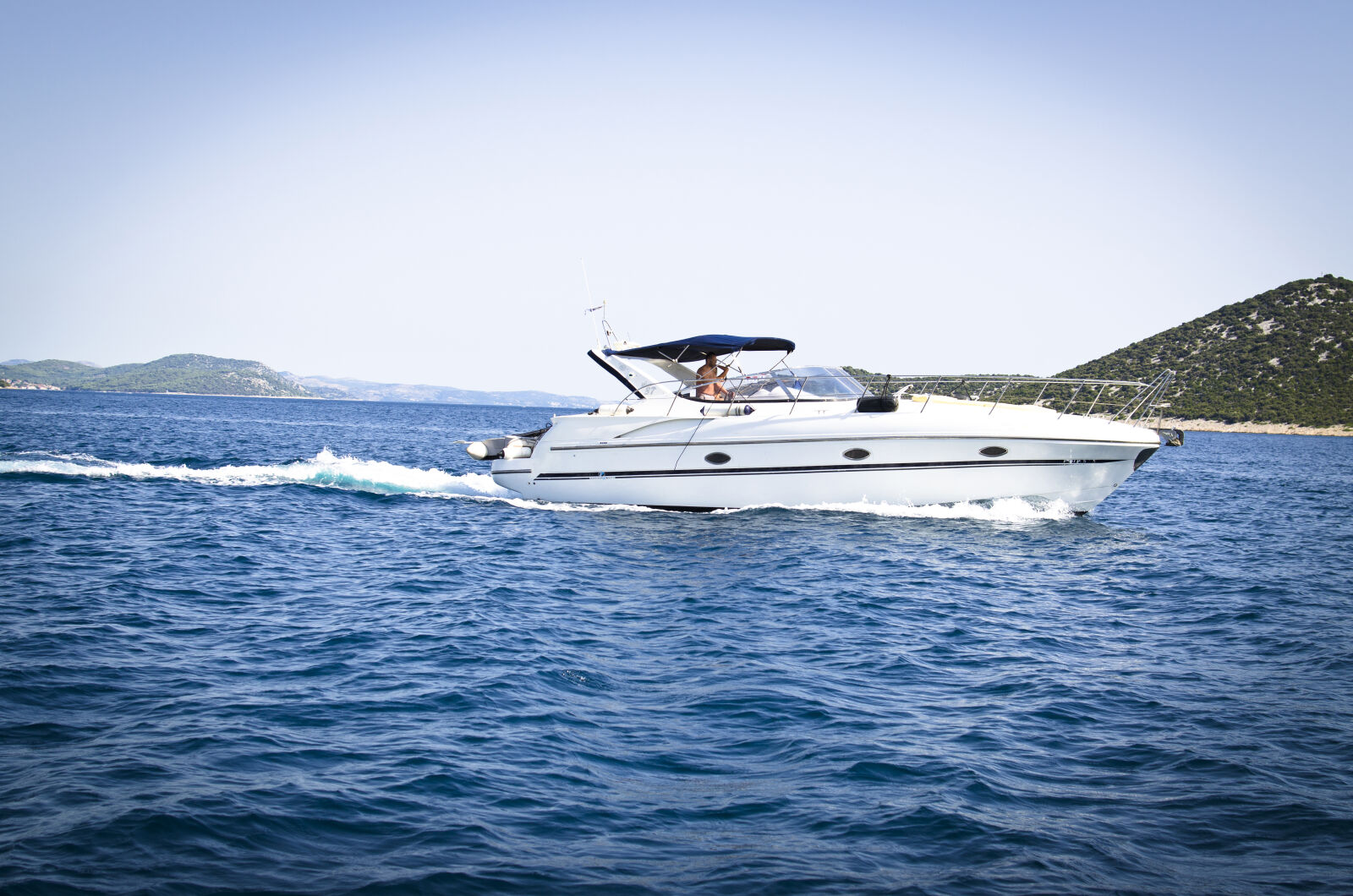 Nikon D5100 + Nikon AF-S DX Nikkor 35mm F1.8G sample photo. Blue, boat, clouds, coast photography