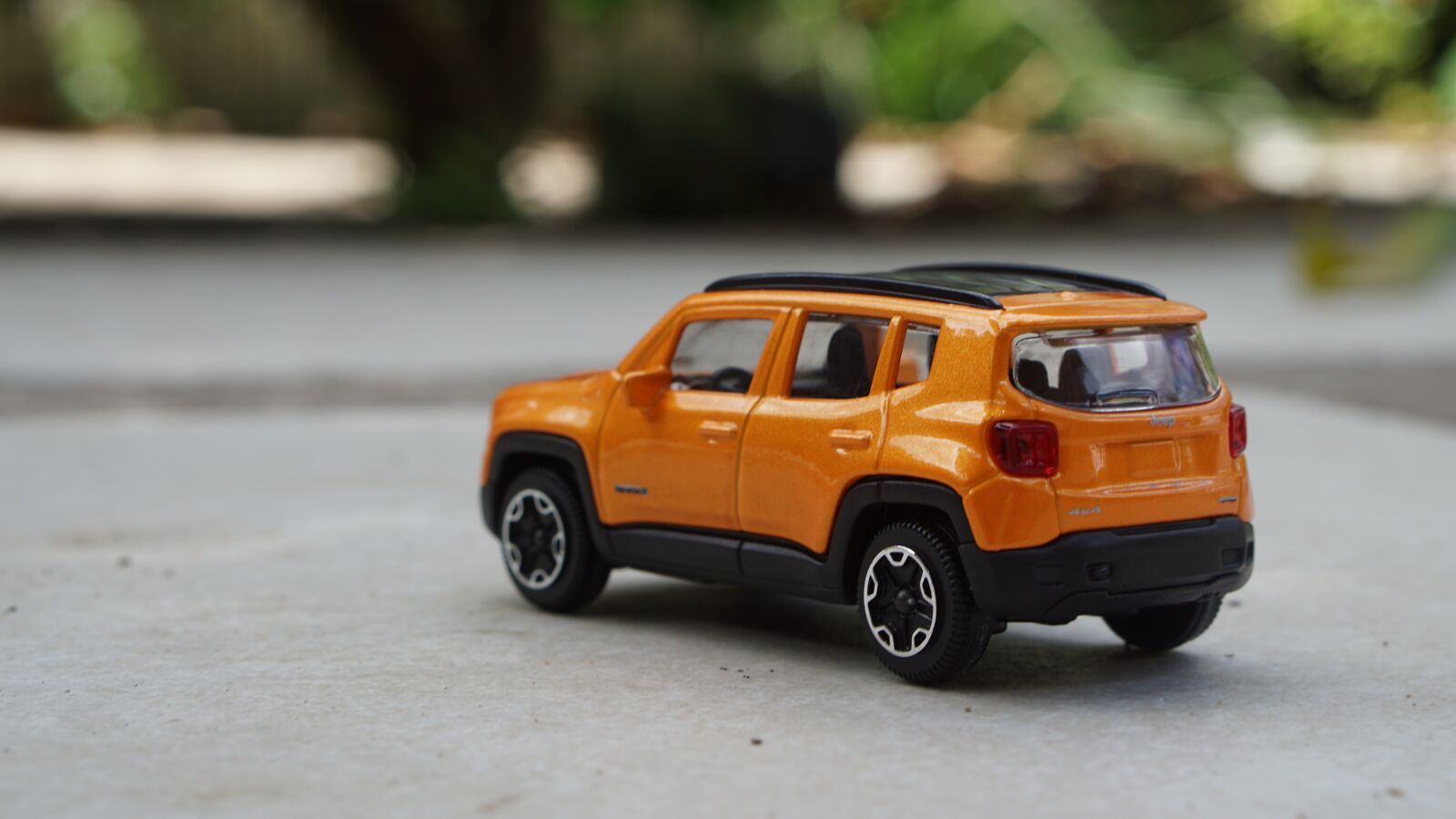 E 50mm F1.8 OSS sample photo. Toy, jeep, yellow photography